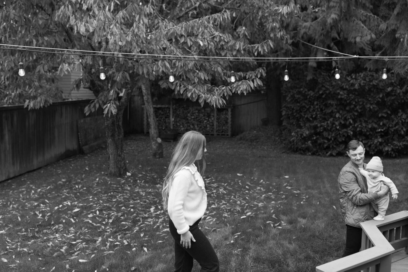 Mom and dad playing with child in their backyard in Portland, Oregon