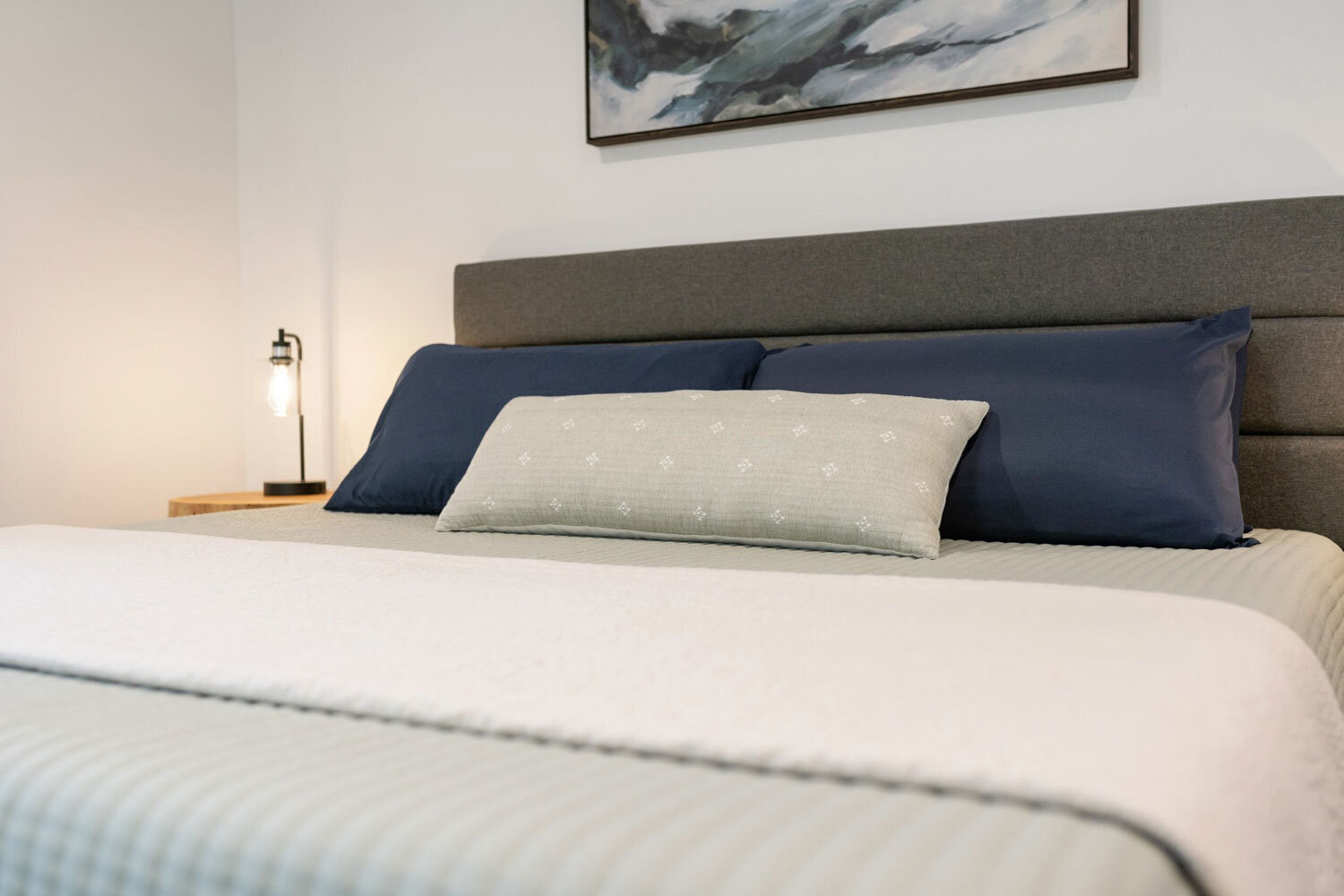 Cozy bedroom with a gray upholstered bed and pillows