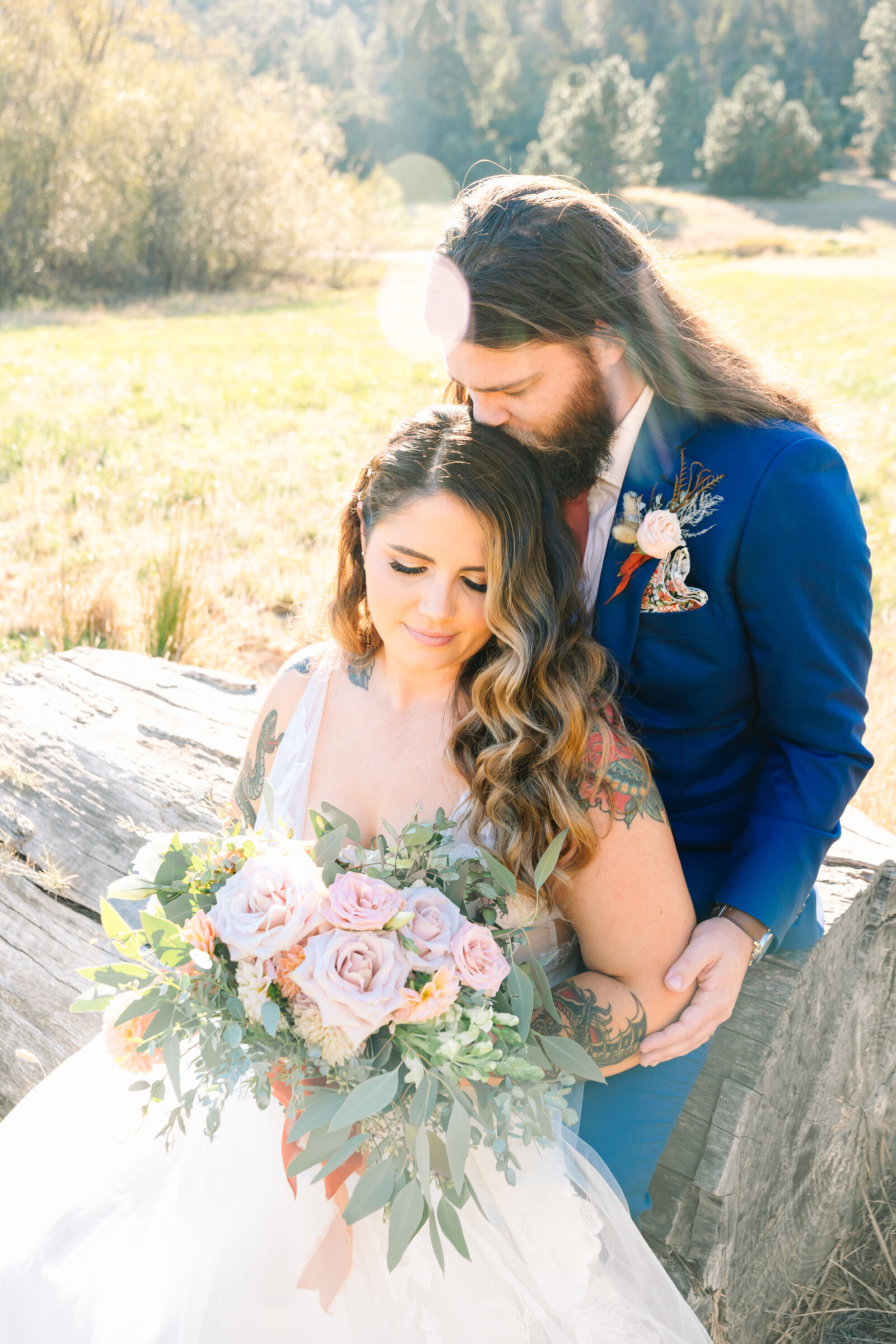Tattoo bride and groom embrace on their colorful wedding day in Santa Cruz, California.