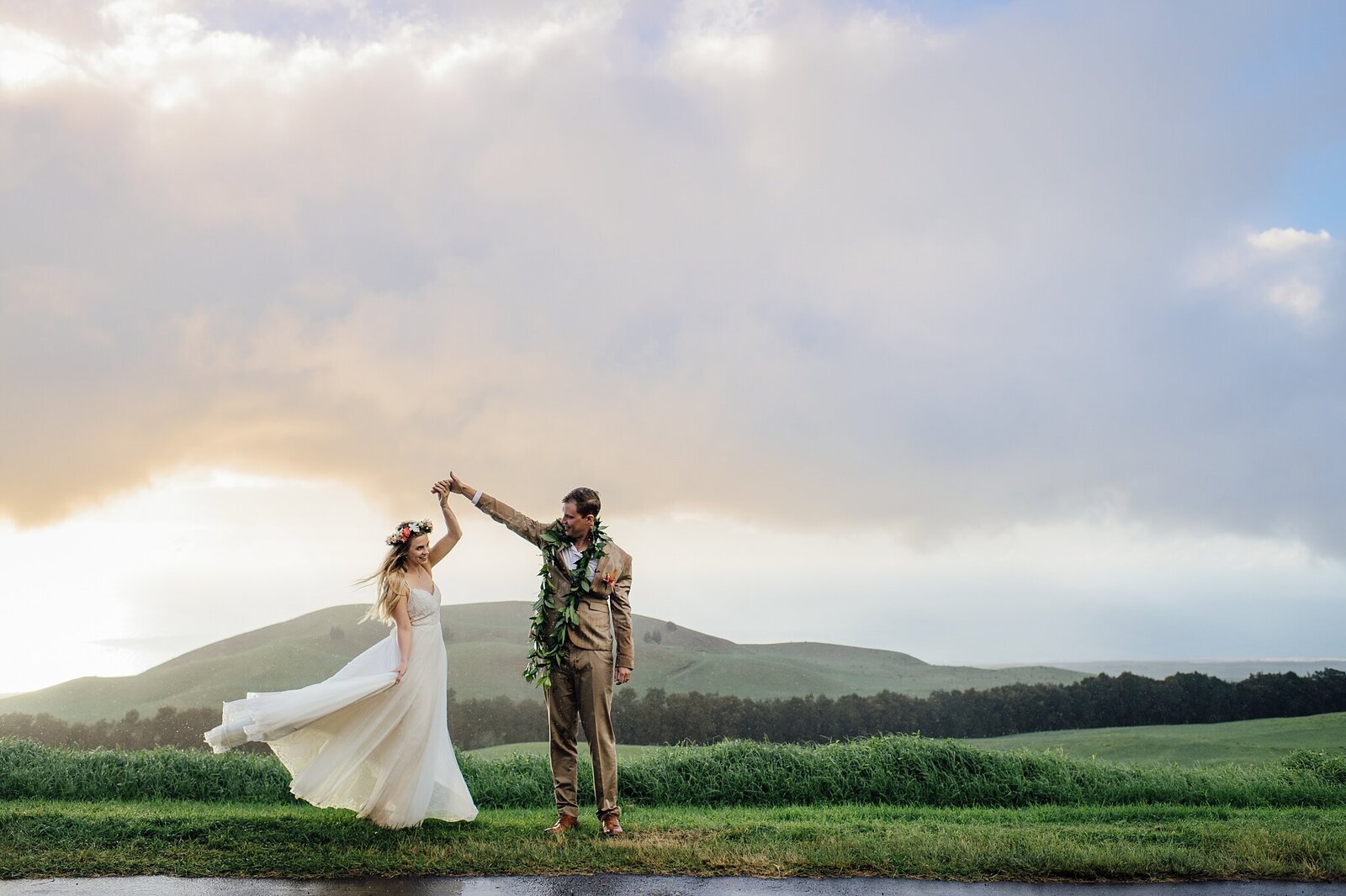 groom twirls bride at their wedding at Kahua Ranch in Hawaii