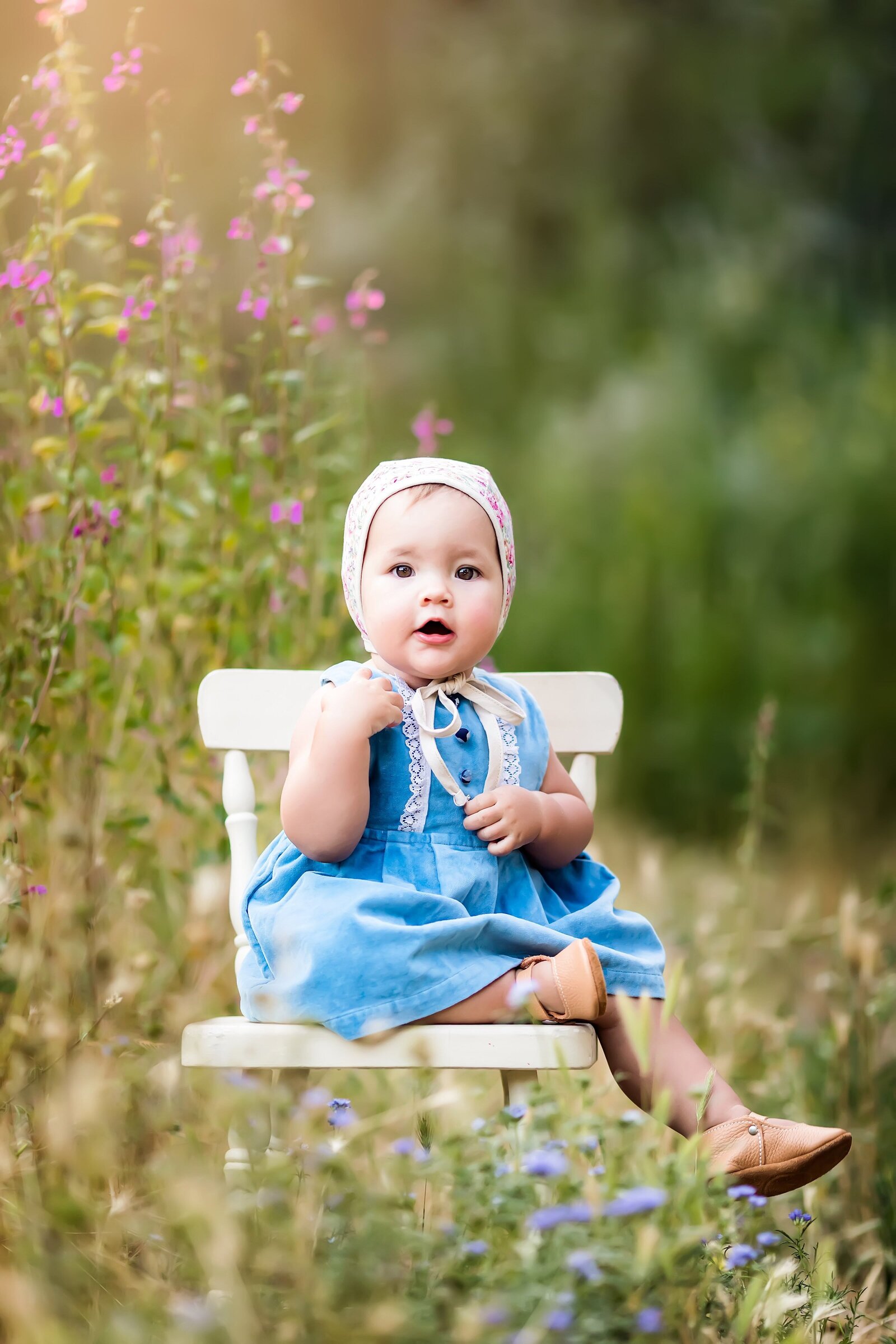 baby girl posing in a flower field