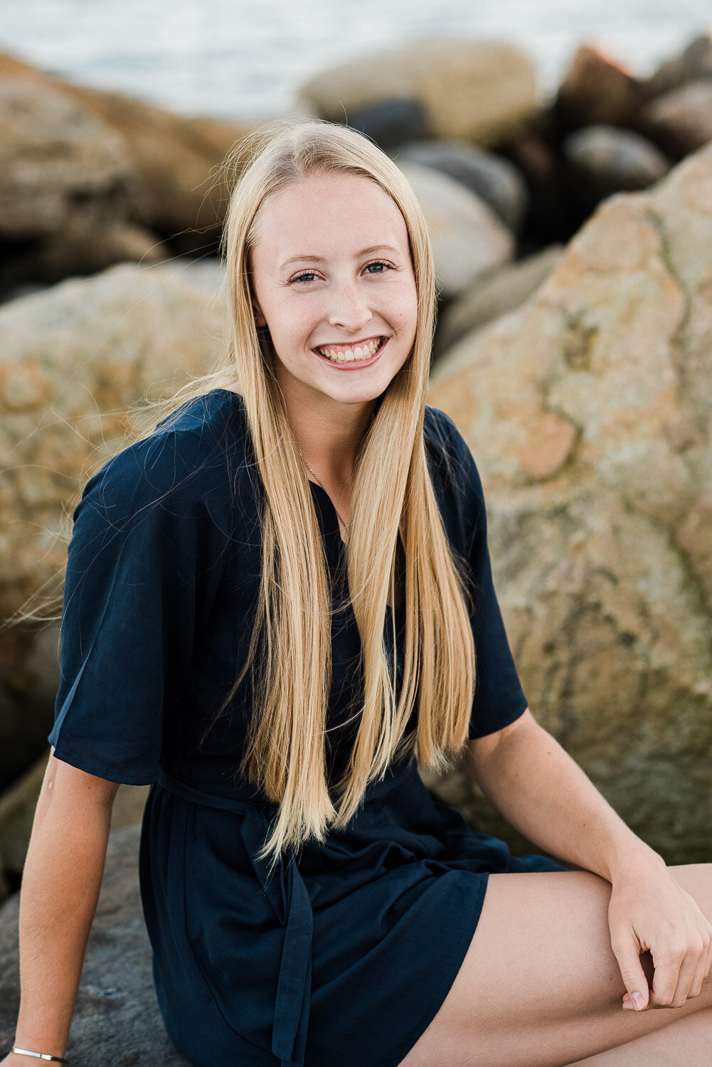 senior girl sitting on rocks