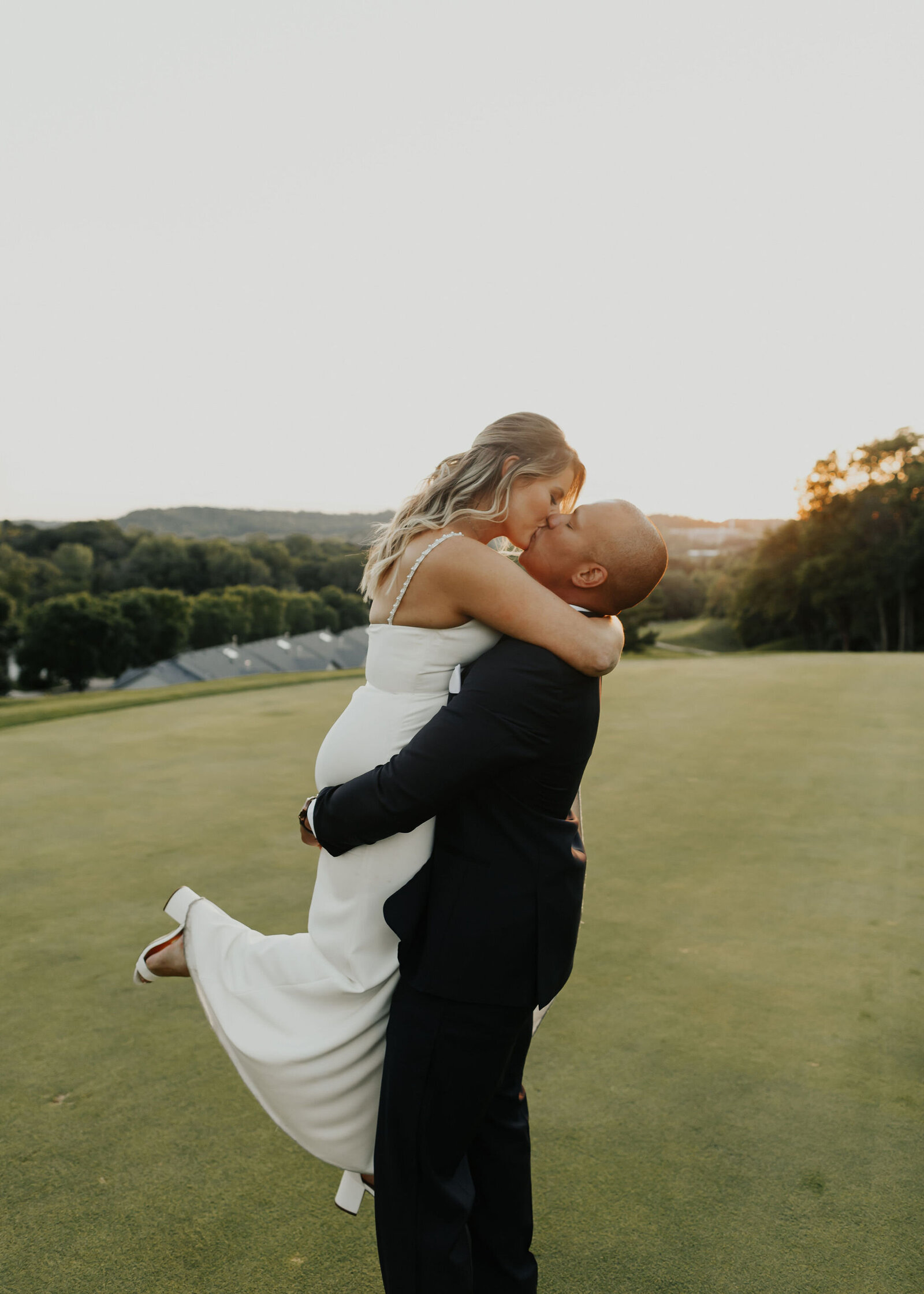 sunset-portrait-bride-groom-wedding-hug-kiss