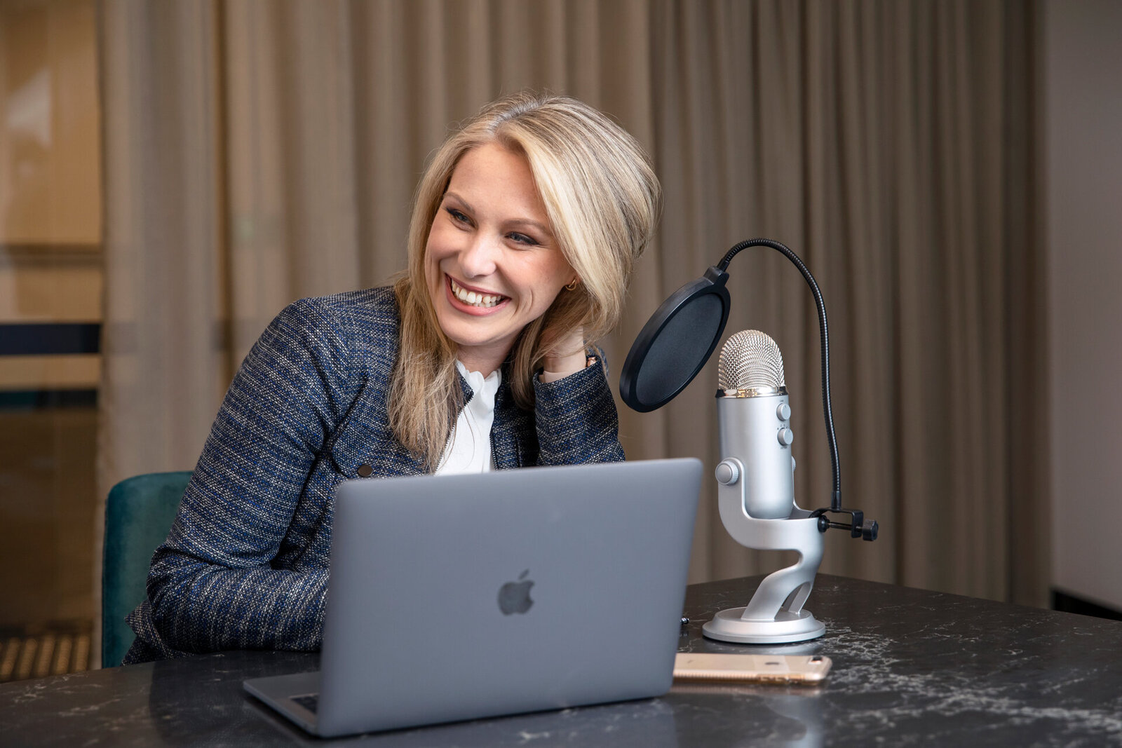 Business woman recording a podcast