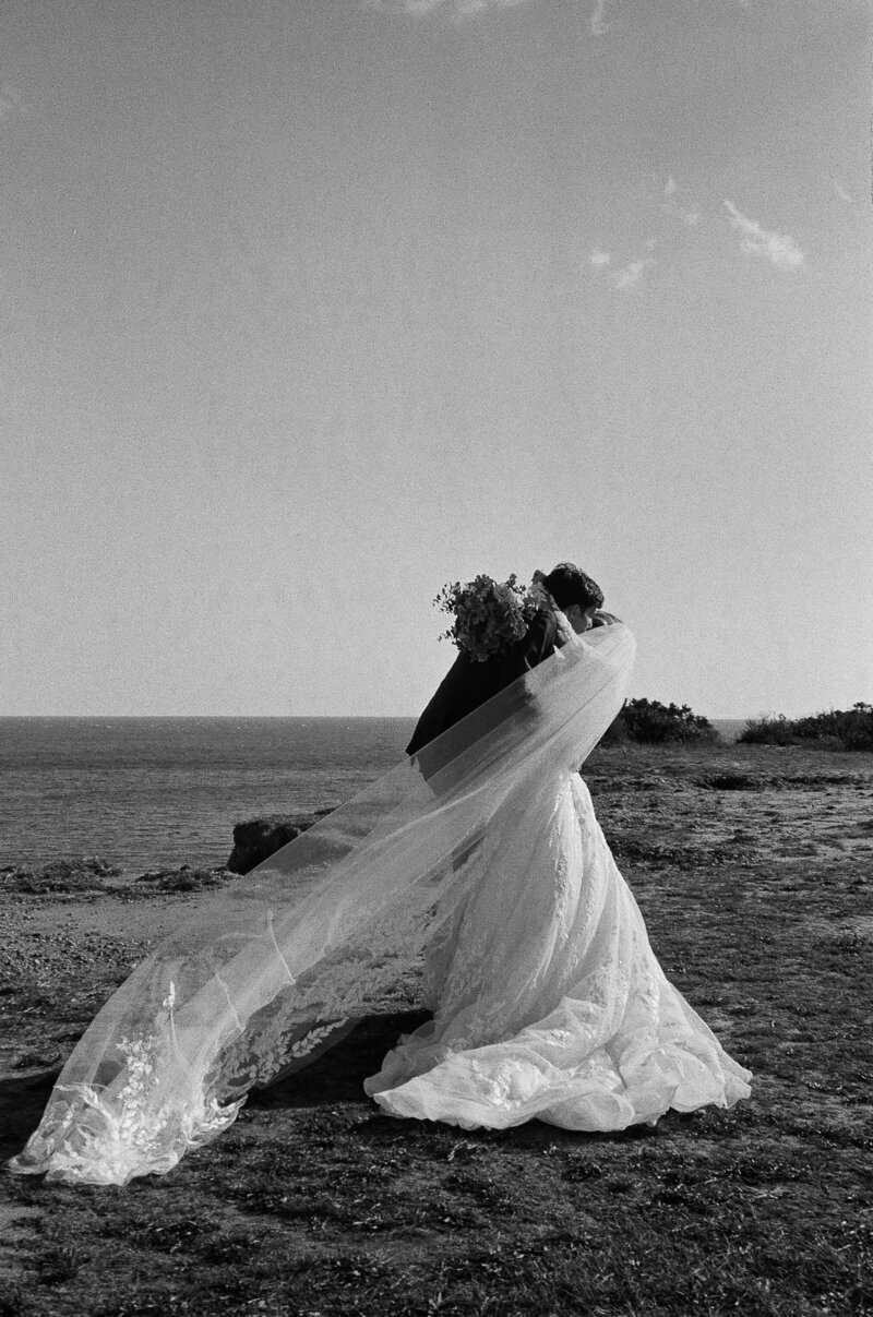 bride with veil blowing in the wind at fort myers wedding