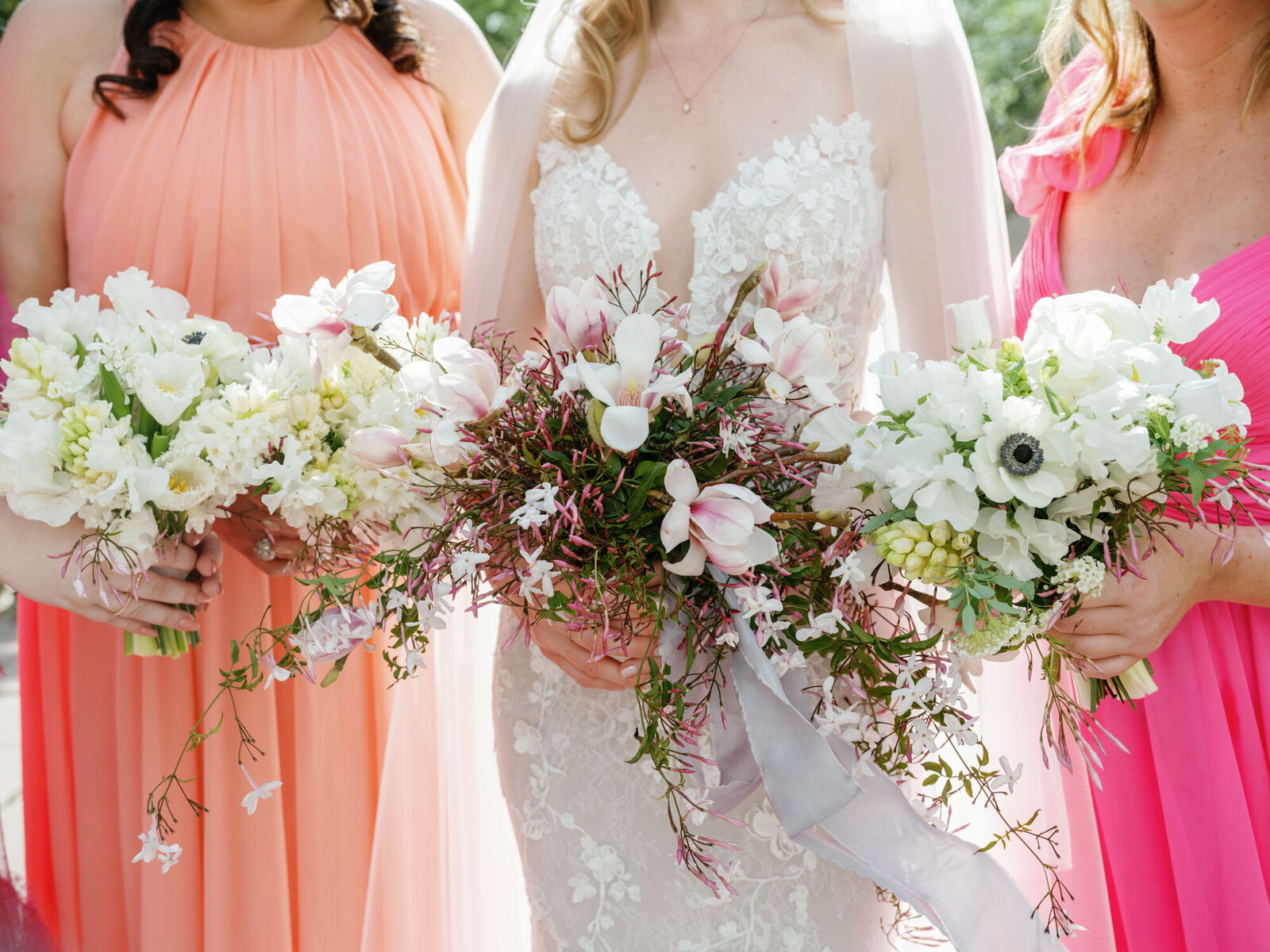 bride standing with bridesmaids with colorful bridesmaid dresses
