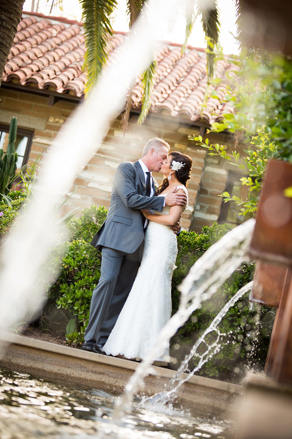 Creative use of fountains to frame the bride and groom.