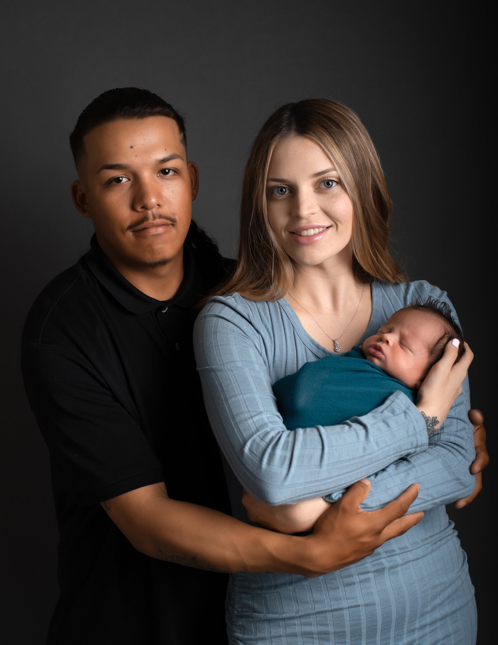 family posing with newborn