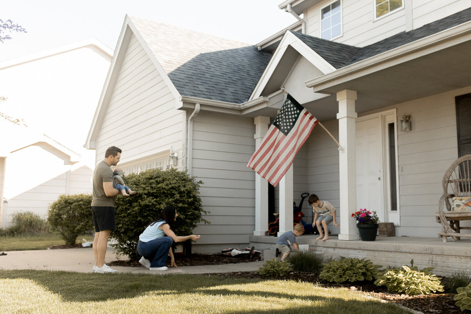 Des Moines family playing on their front porch