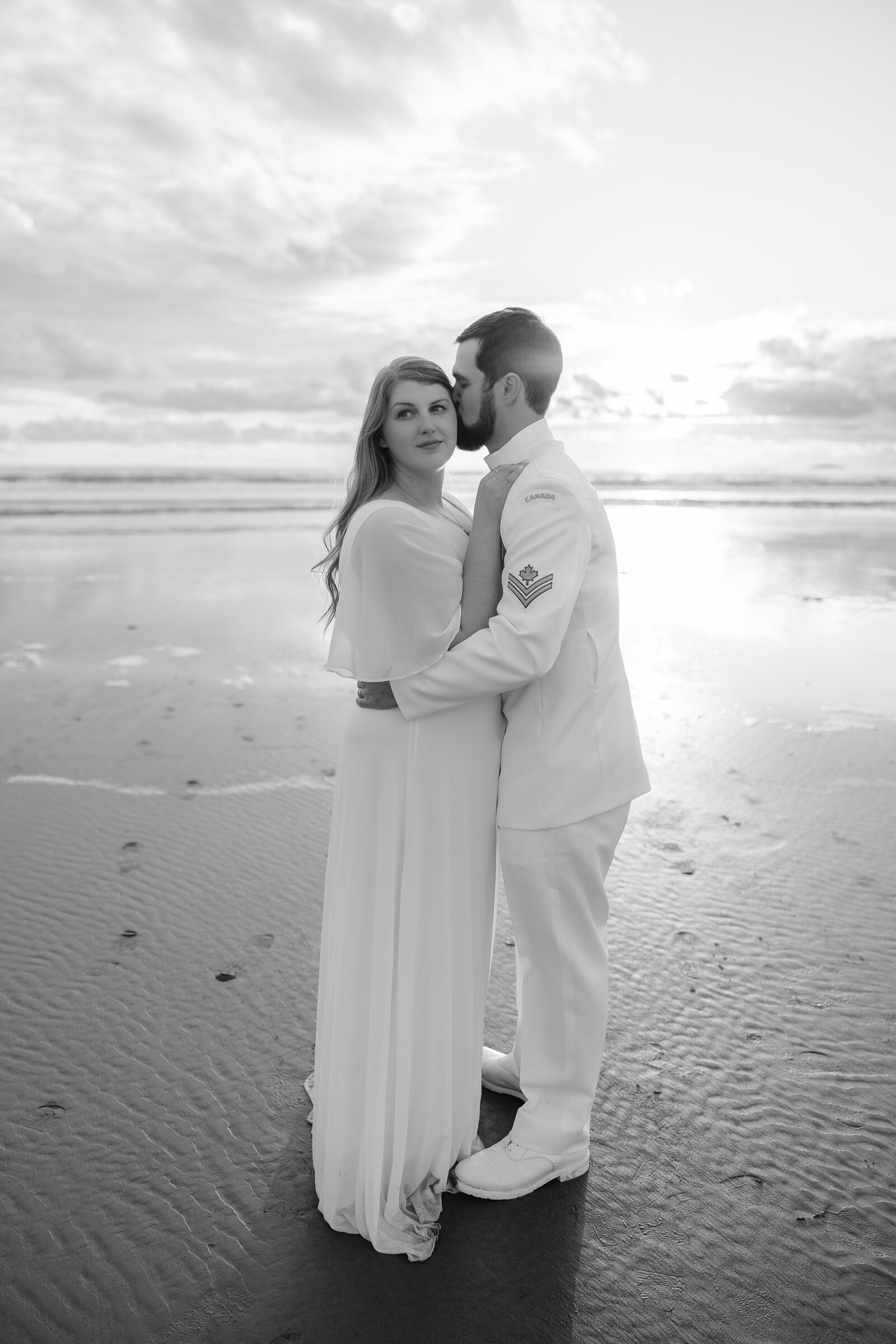 A couple poses for a wedding portrait in Clam Harbour after their backyard wedding. 