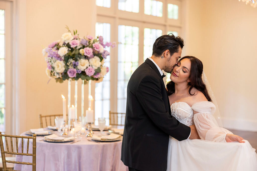 A romantic indoor wedding at  Central Florida Luxmore Grande Estate complete with beautiful silk floral arrangements. Perfect for couples dreaming of a unique and luxury-filled celebration.