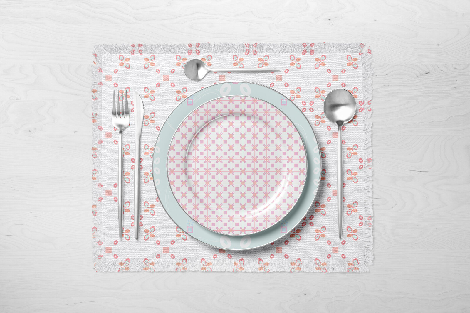 pink and white patterned placemat and dinner plates