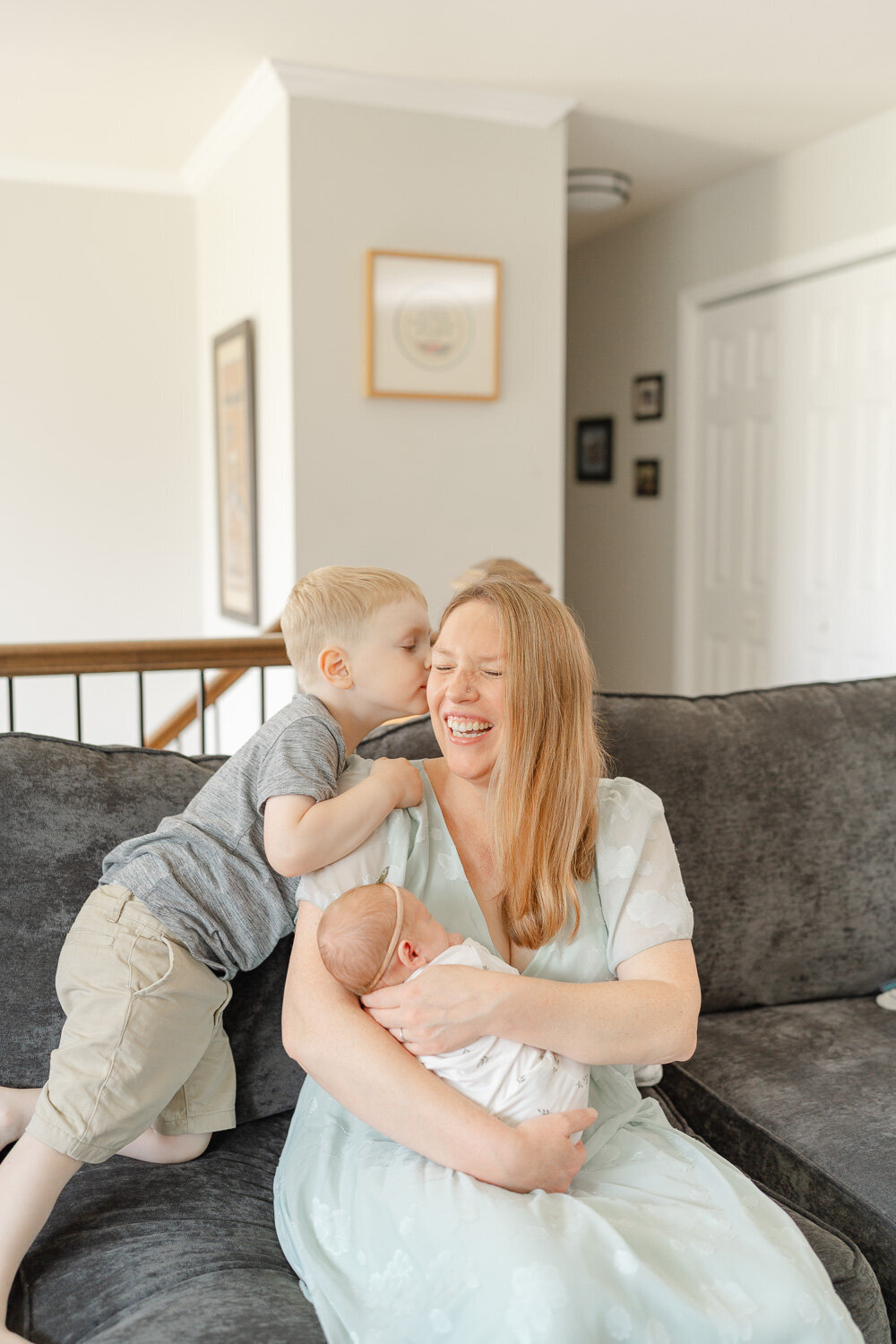 big brother whispering to mom during newborn session in McLean, VA