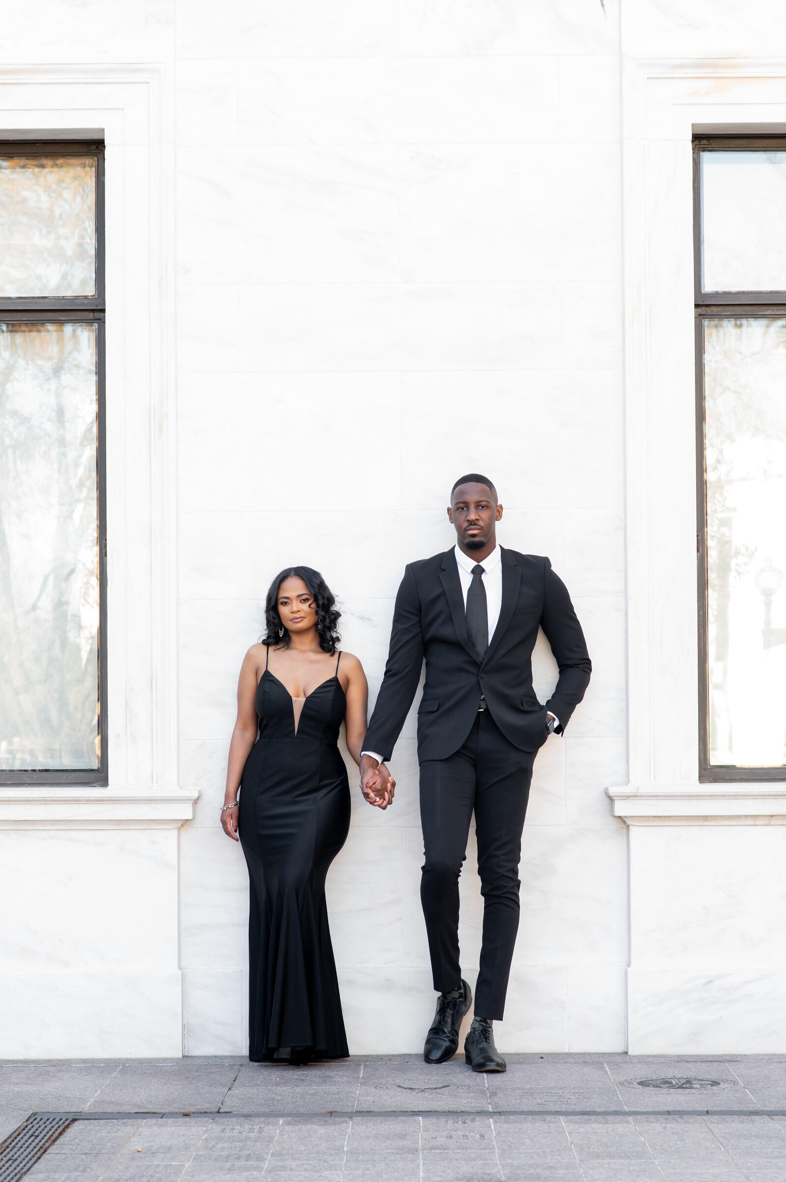 couple leaning on wall