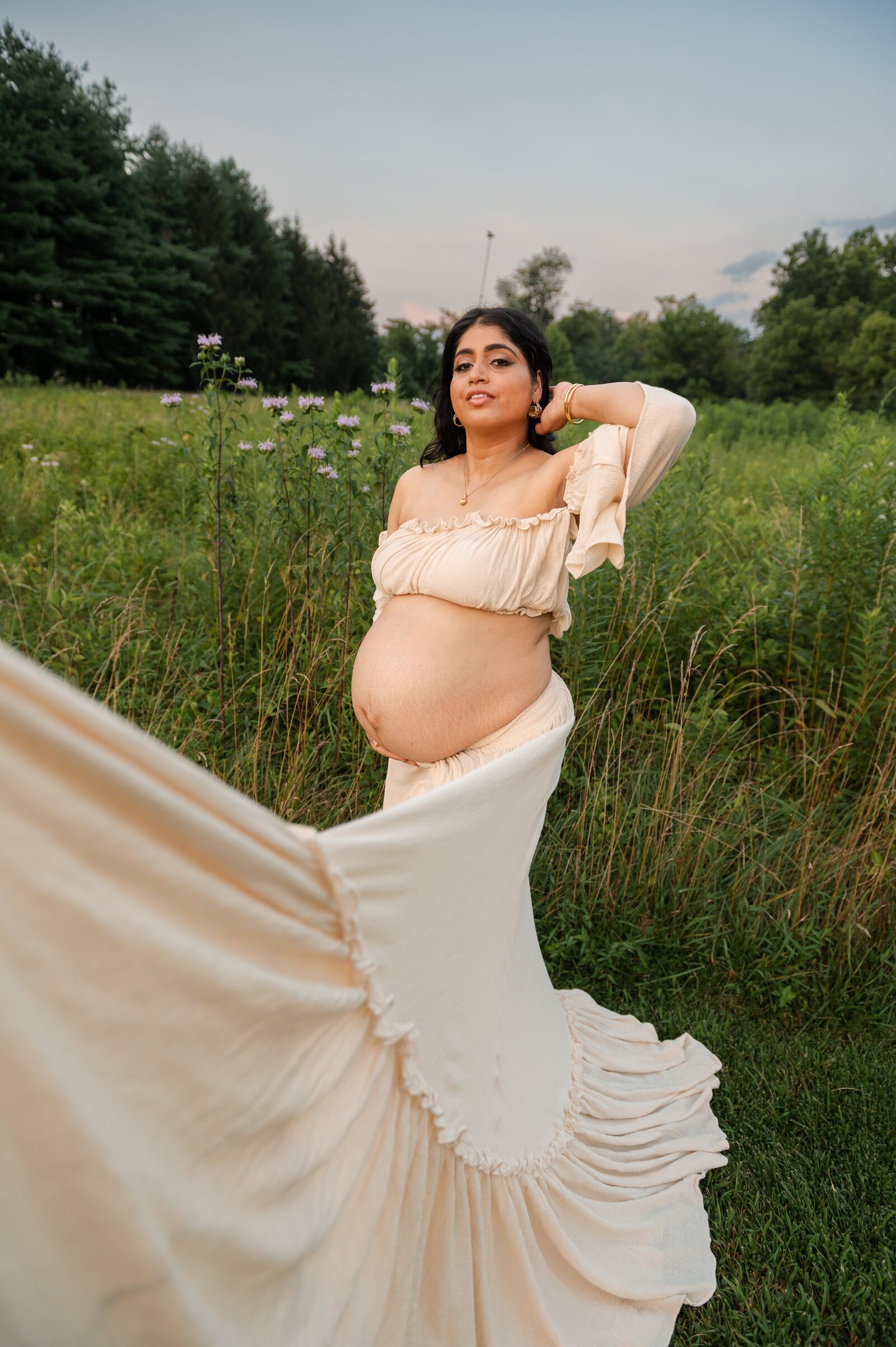 Pregnant mom with dress showing belly during a maternity photoshoot