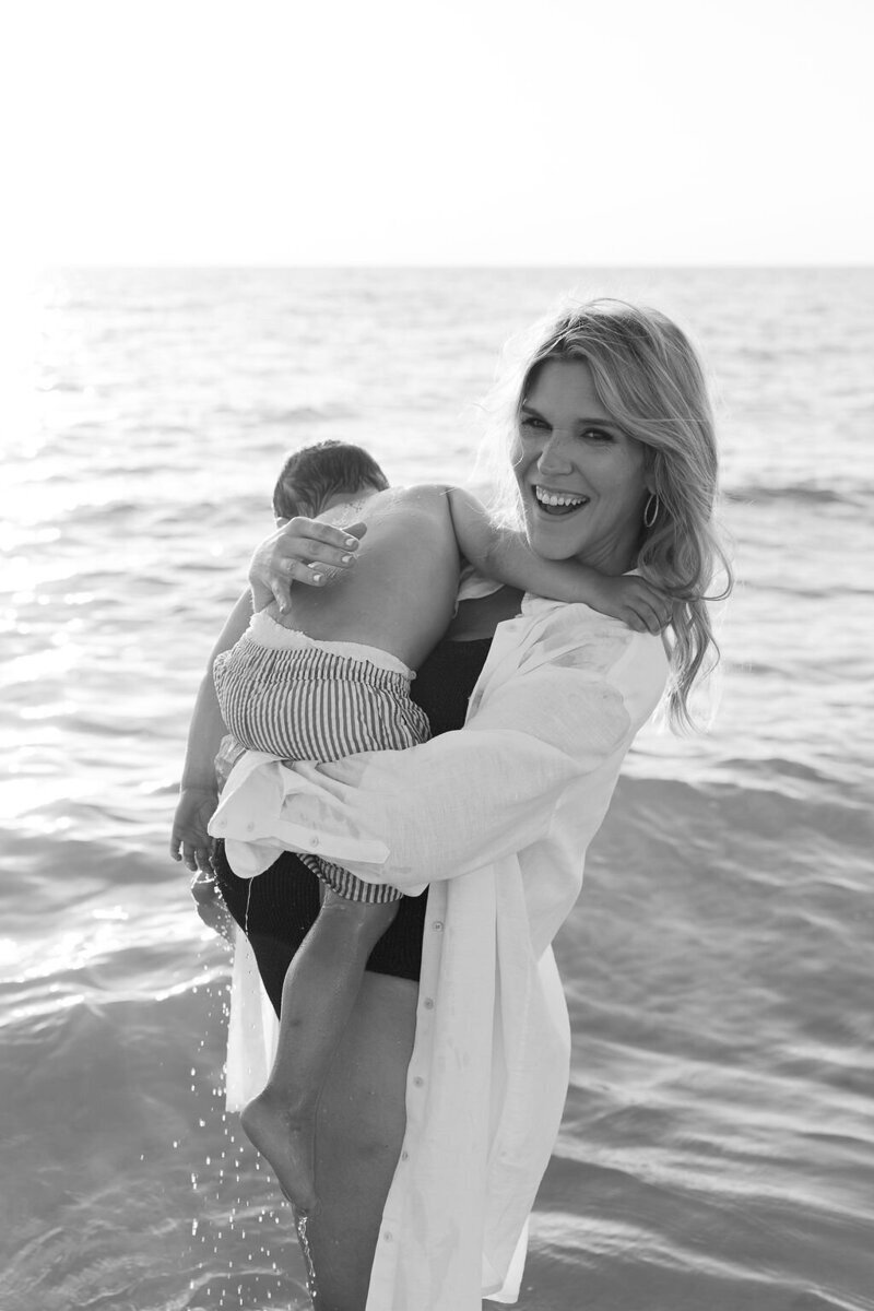 mom holding son in the ocean, taken by naples fl family photographer
