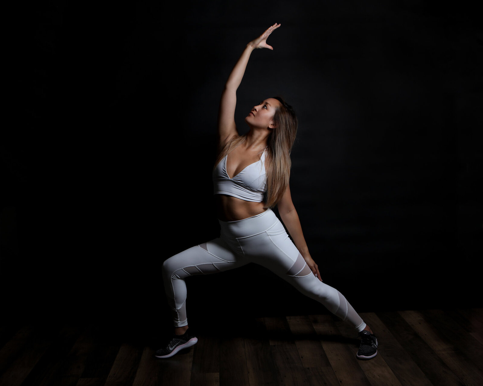 Yoga Instructor Yoga Pose In Studio with a Dramatic Black Backdrop