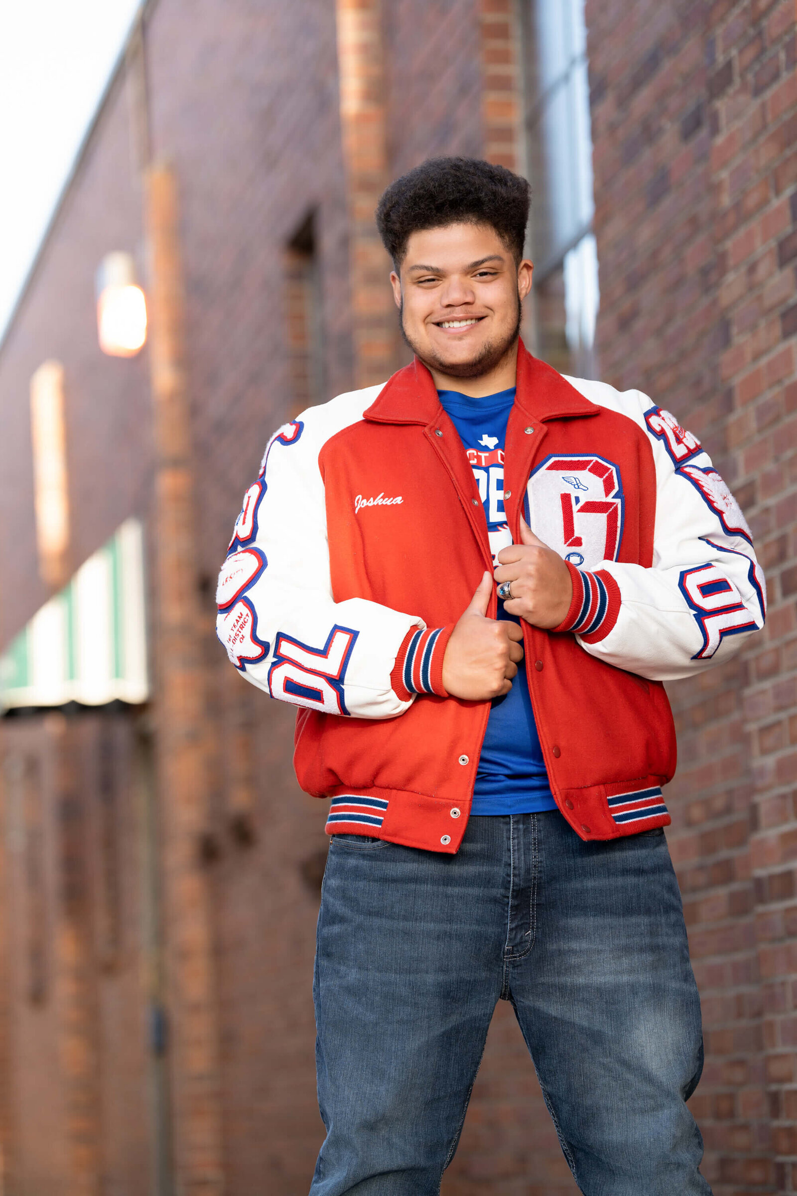 senior-guy-smiling-letter-jacket