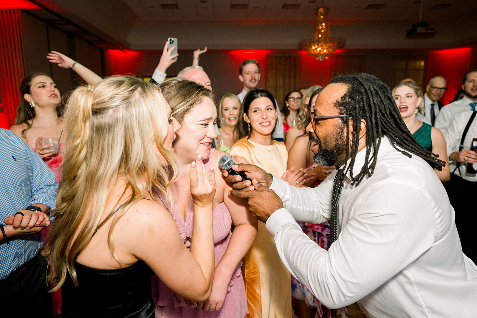 Wedding guests singing with a microphone on the dance floor