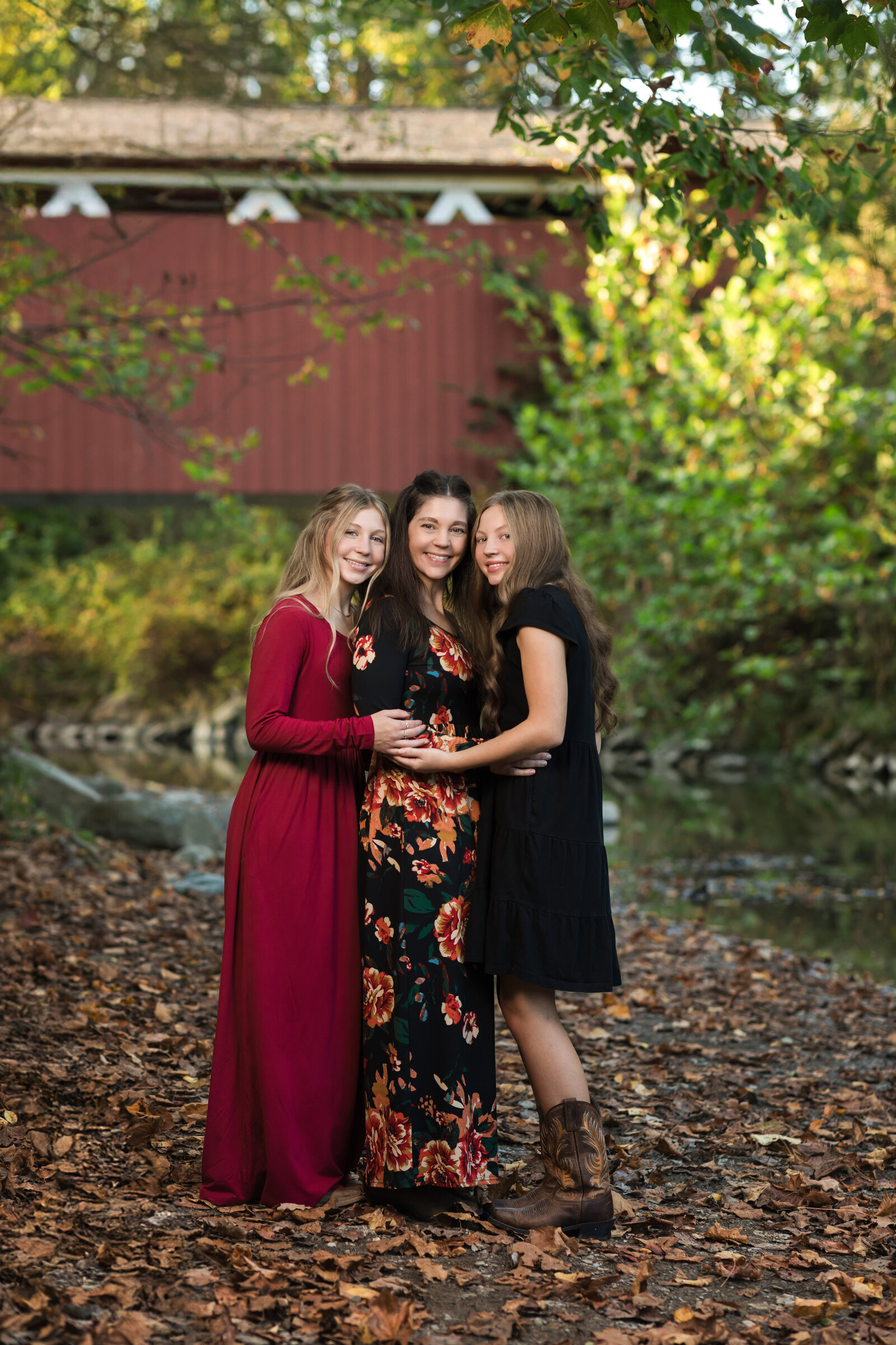 mother and two daughters hugging in park for fall family photos Cleveland  family photography