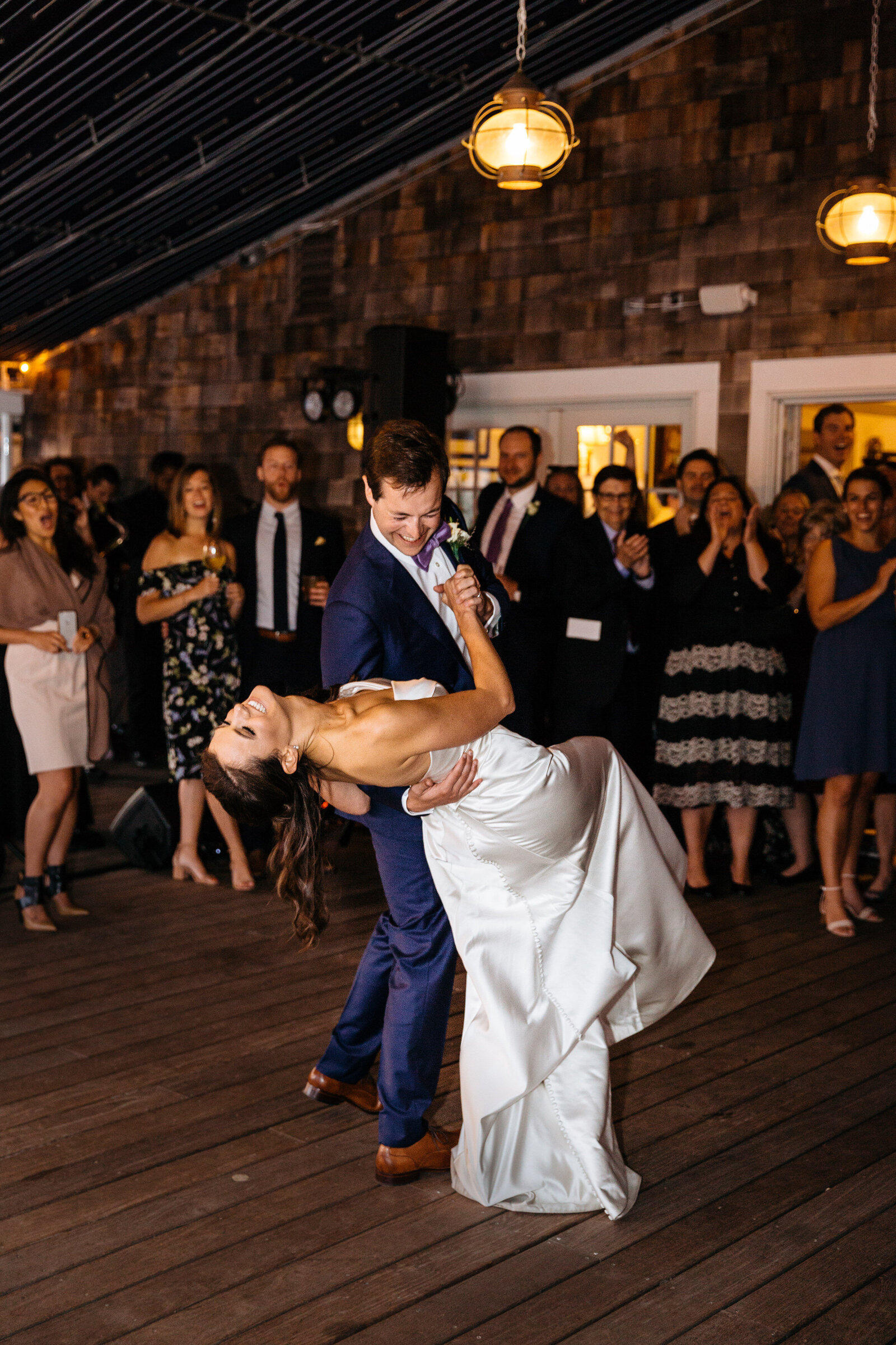 A groom dipping a bride during their first dance.