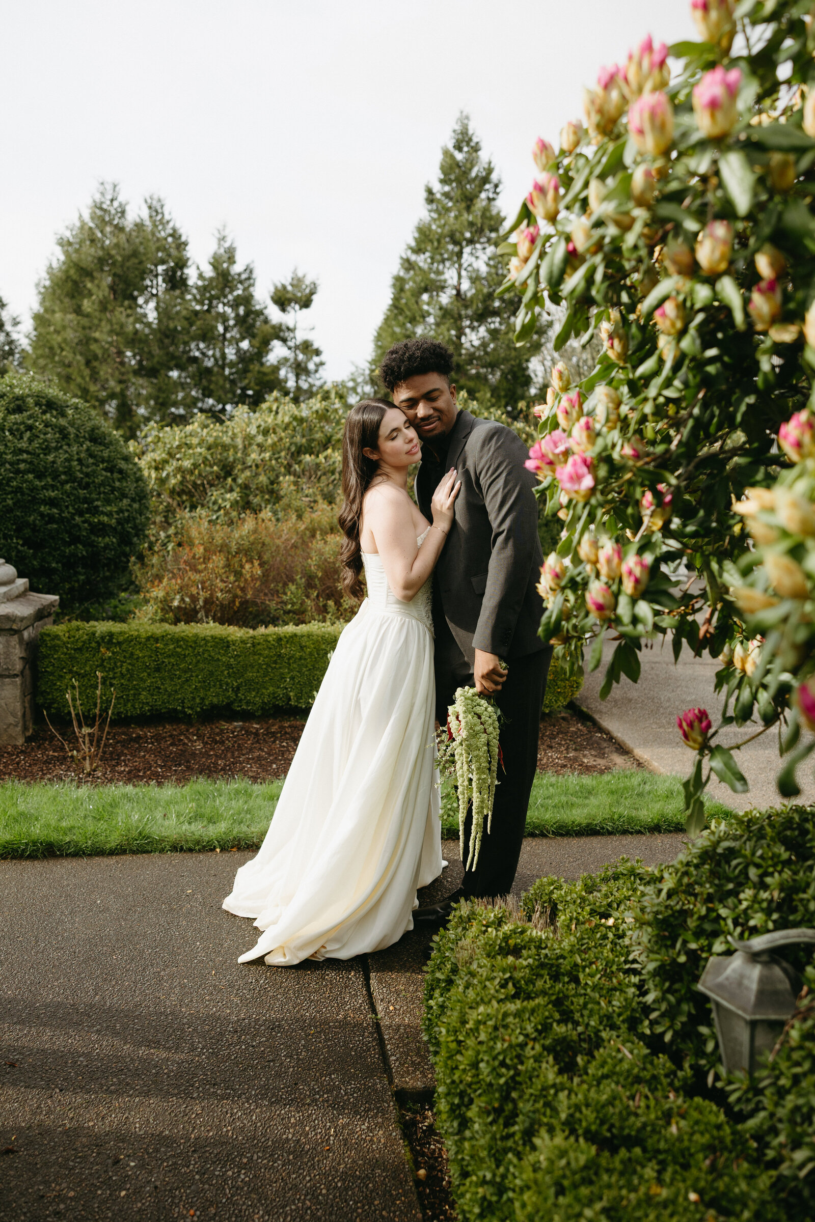 A bride and groom pose for their bridal portraits at a beautiful chateau in Vancouver.