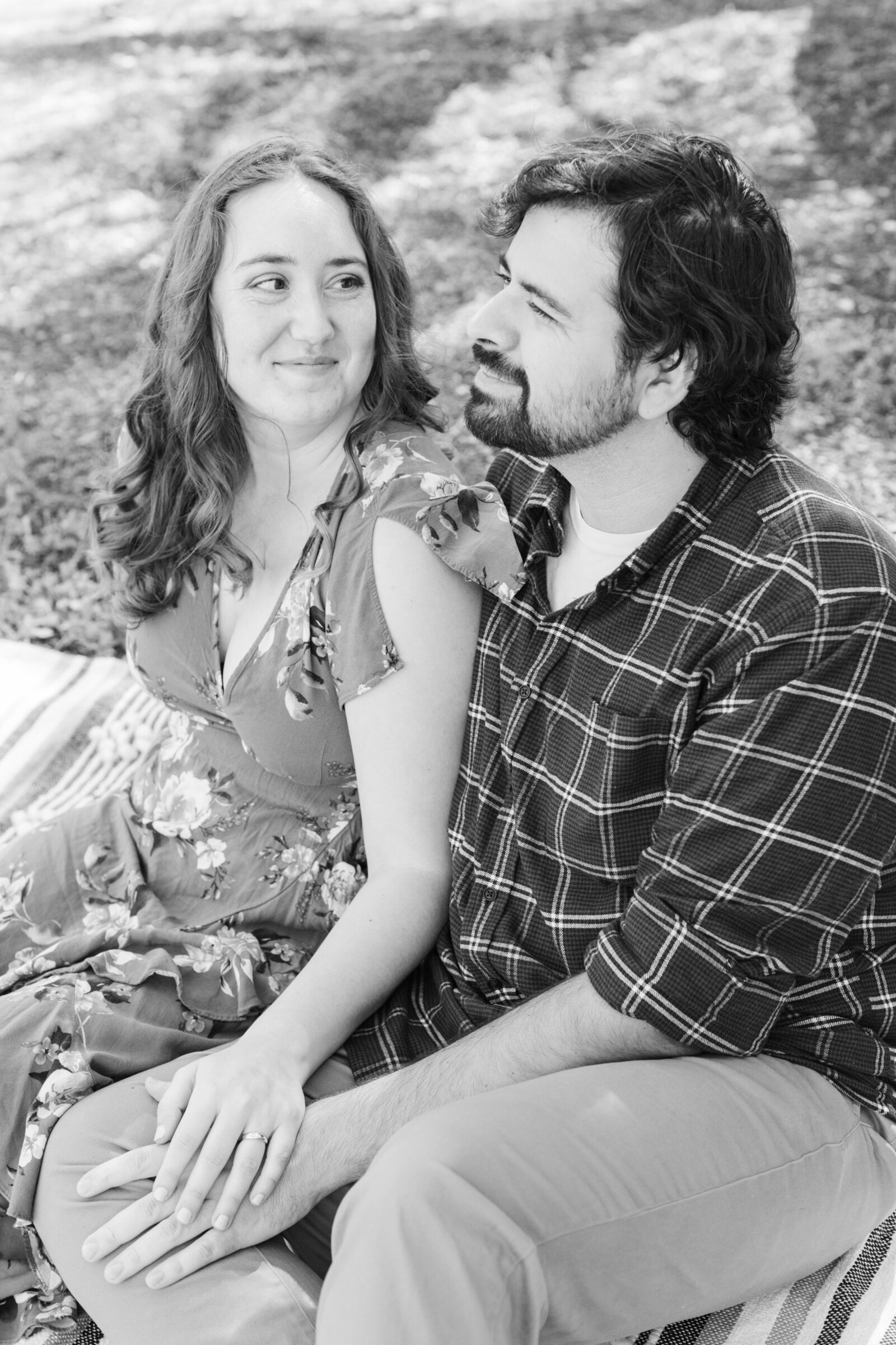 An engaged couple poses for photos in a garden in Los Angeles, Ca.