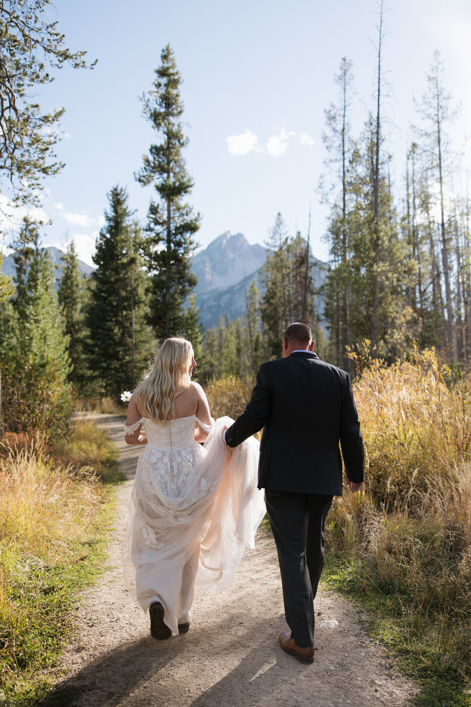 Father of bride walking bride to private elopement ceremony in Stanley, Idaho