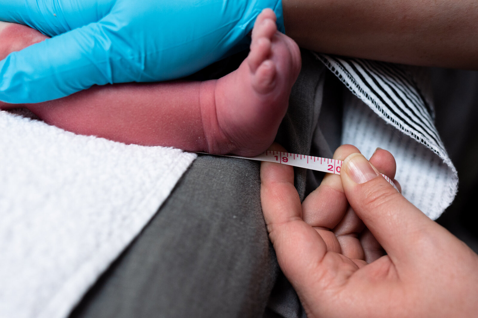 baby measured  by midwife at newborn exam in New Braunfels