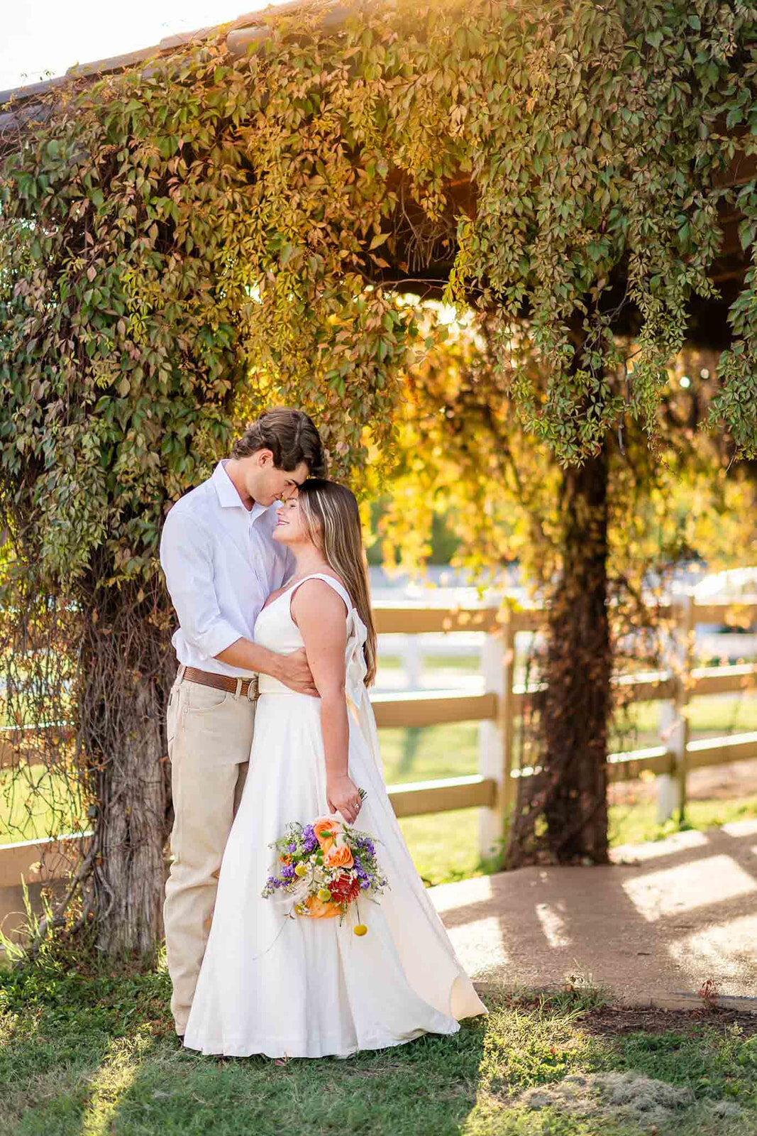 A bride and groom walking hand in hand through a scenic outdoor venue in San Antonio, photographed by CMH Studios.