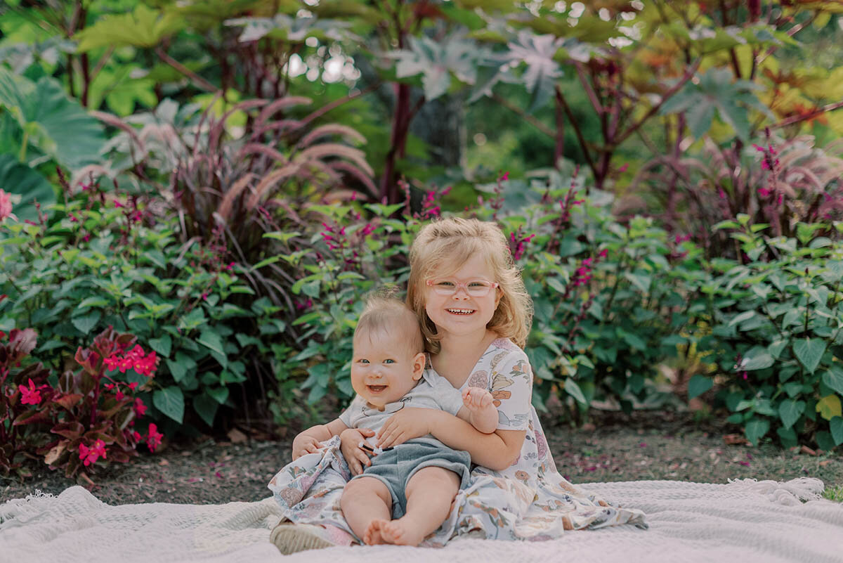 Toddler girl hugging her baby brother in their Chicago family photos