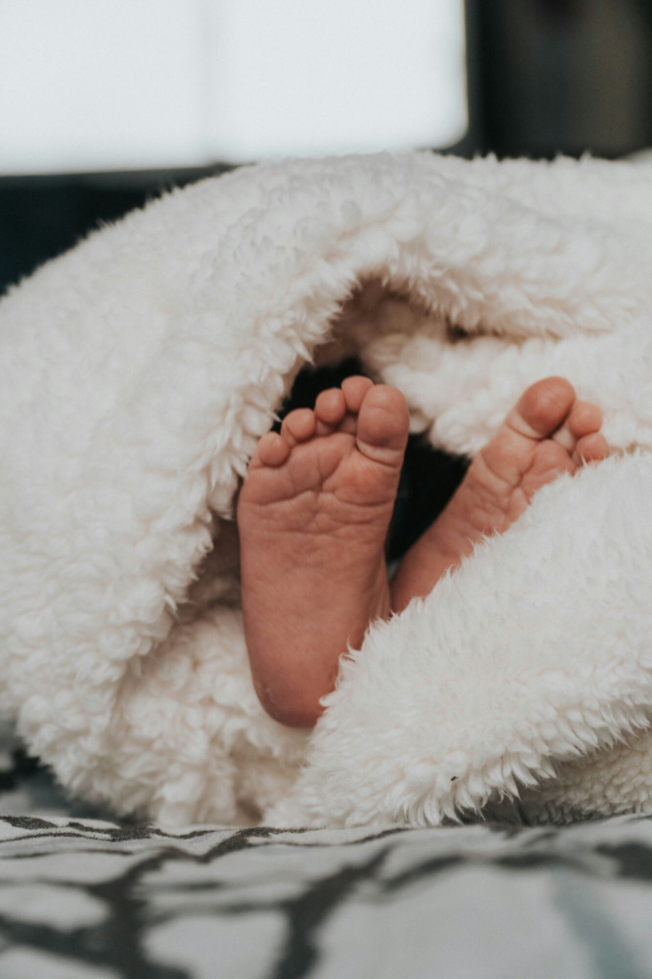 Feet sticking out of a white blanket
