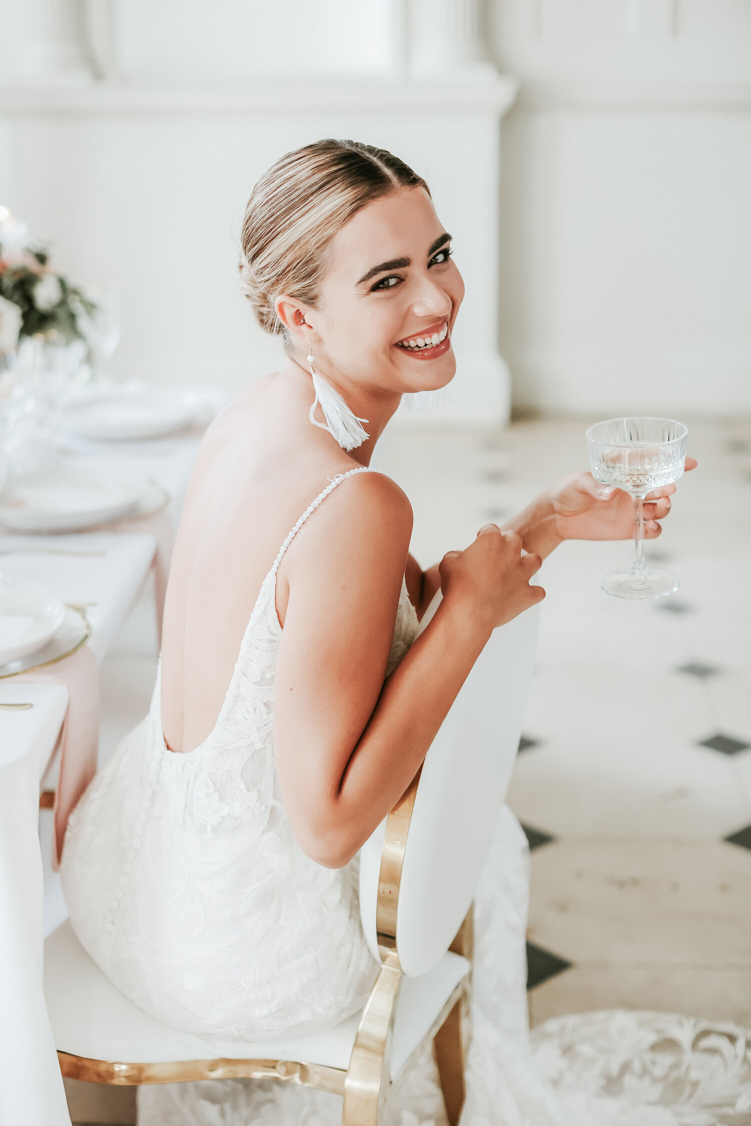 Chicheley-Hall-wedding-venue-bride-holding-champagne