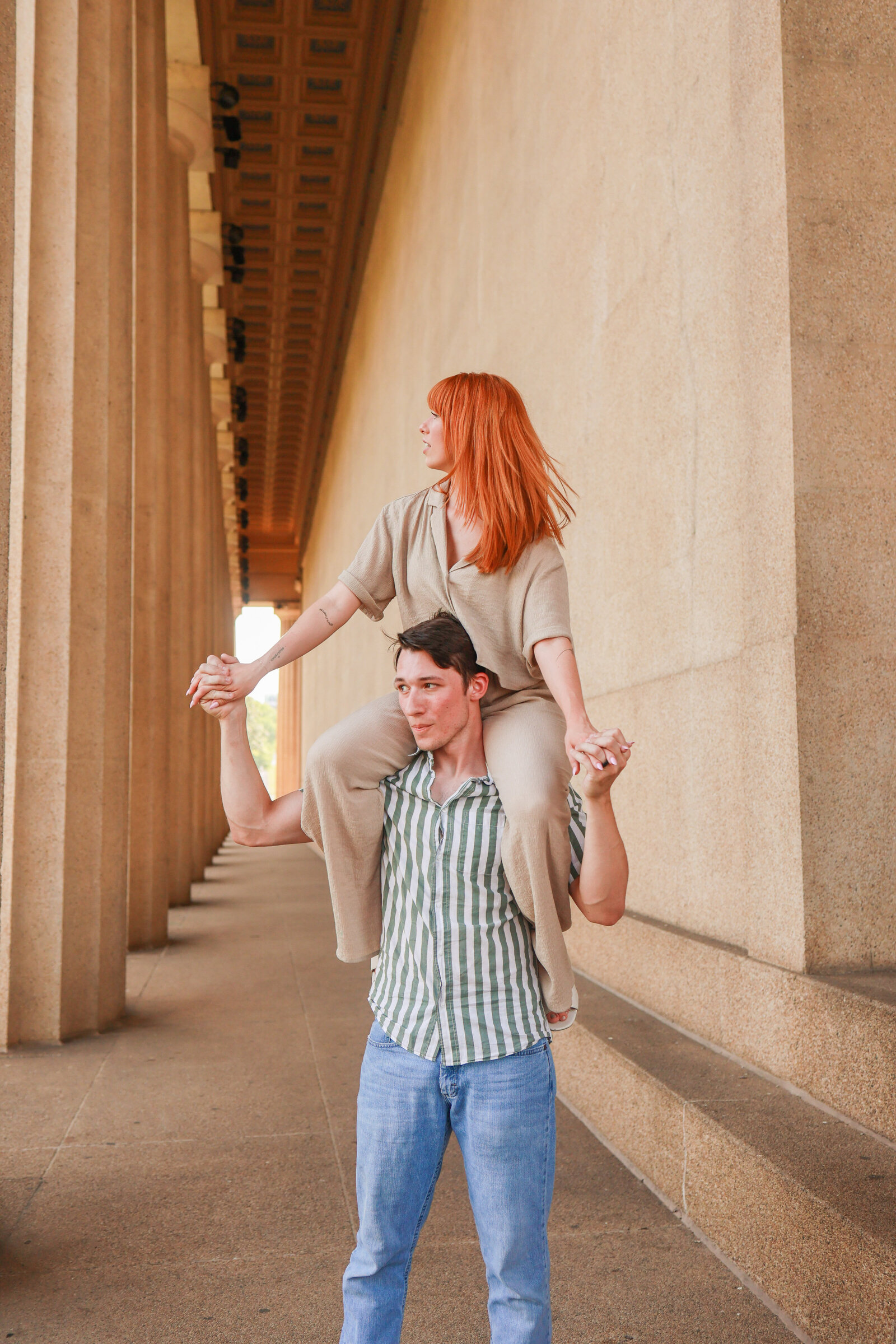 Engaged couple smiling at Partheon in Nashville Tennessee