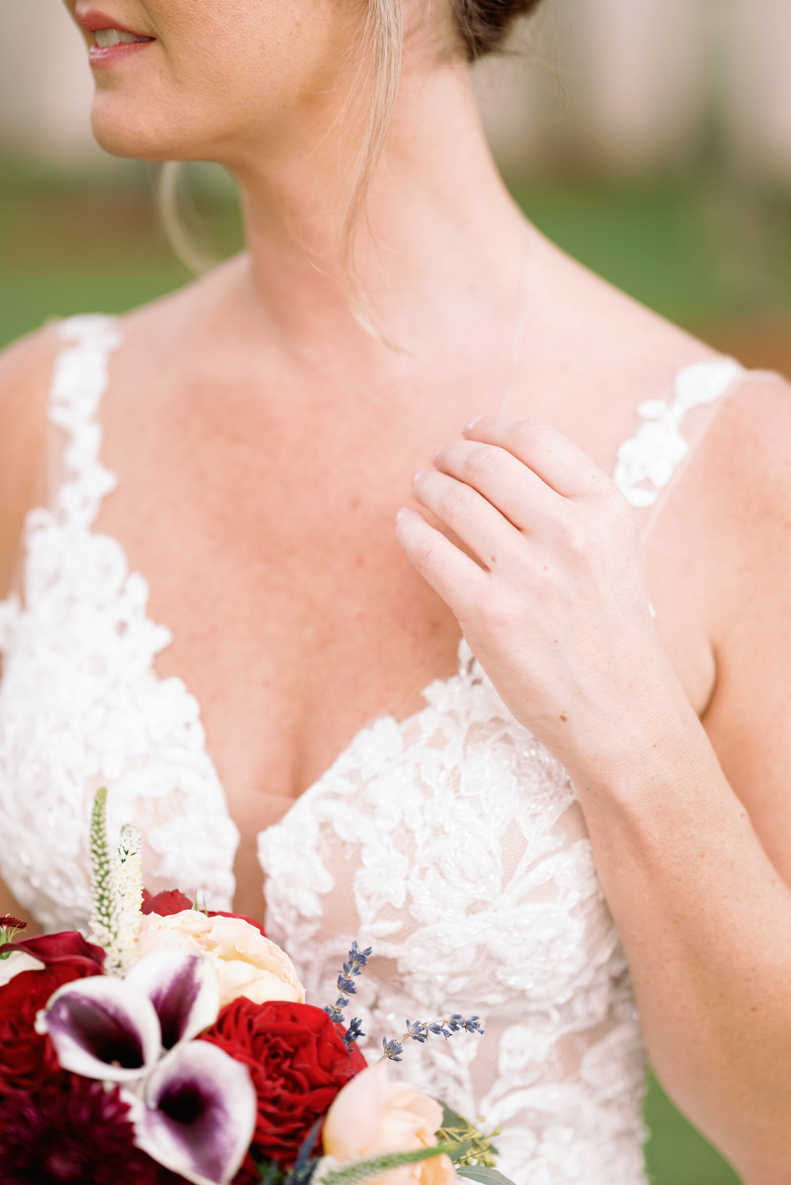 detail of bride playing with her necklace during bridal portraits