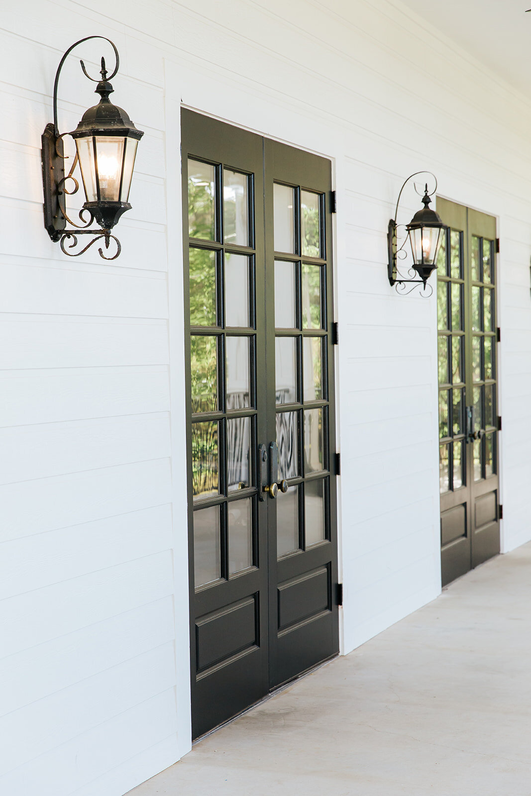 Elegant black doors and sconces at Kendall Point