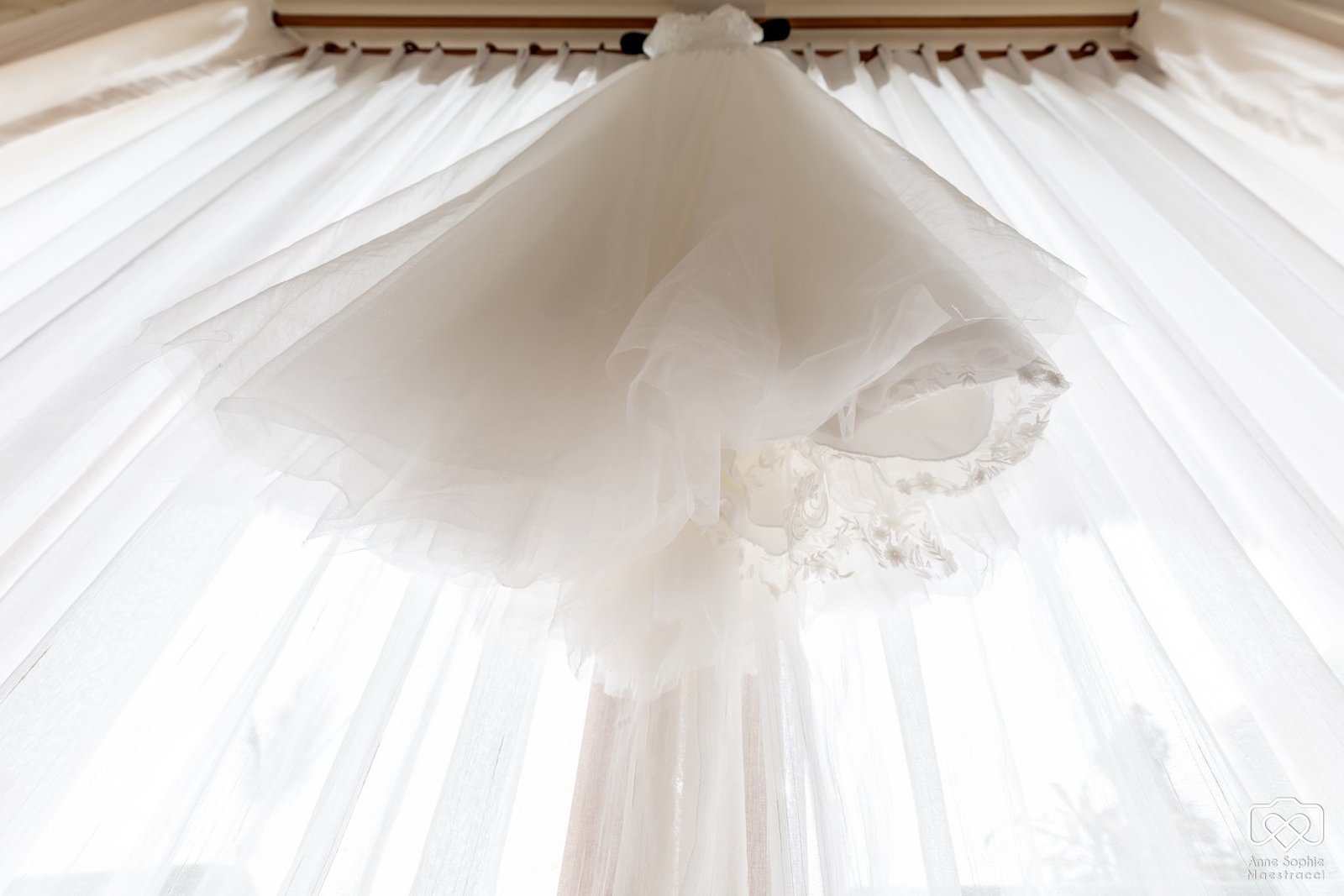 Wedding dress hanging on window
