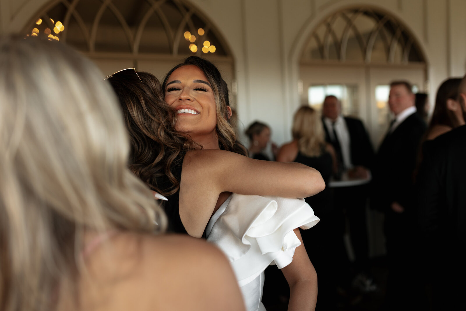 Bride hugging guests at West wind hills Venue outside of St. Louis