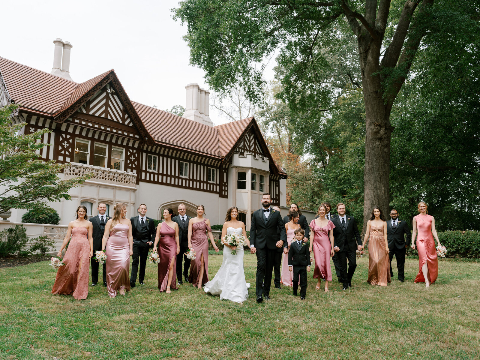 callanwolde walking bridal party in pink dresses and black suits