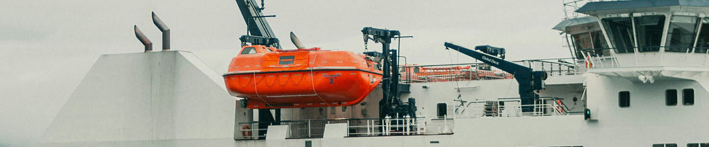 Photograph by Jonathan Cooper of a bright orange safety boat
