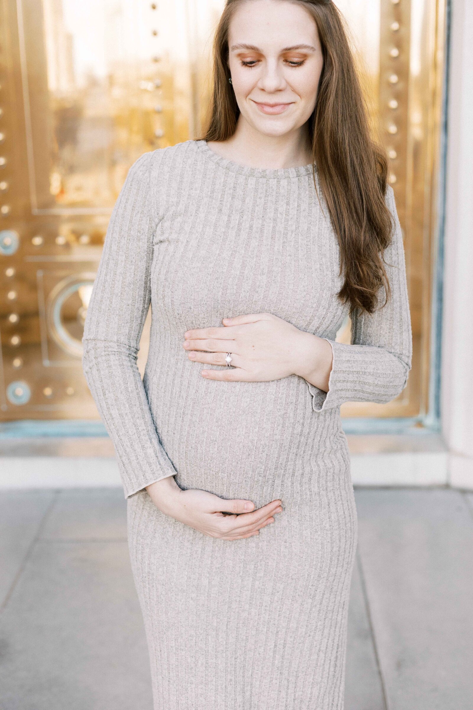 mom holding baby bump during maternity photos in peoria illinois 