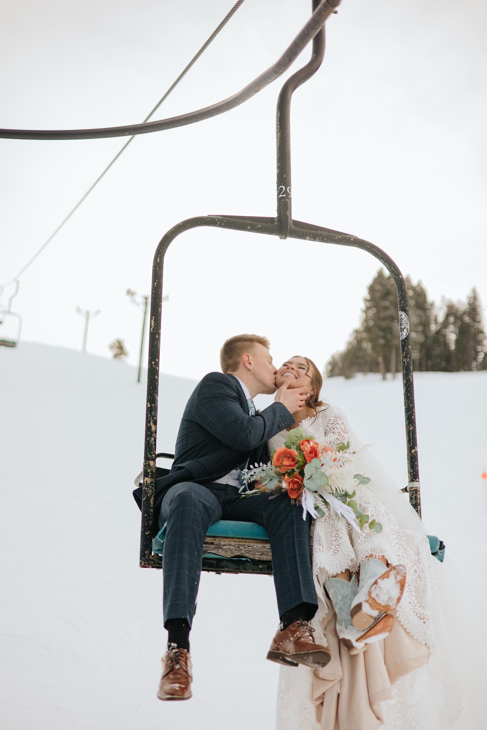 Wedding portrait bride and groom on ski lift