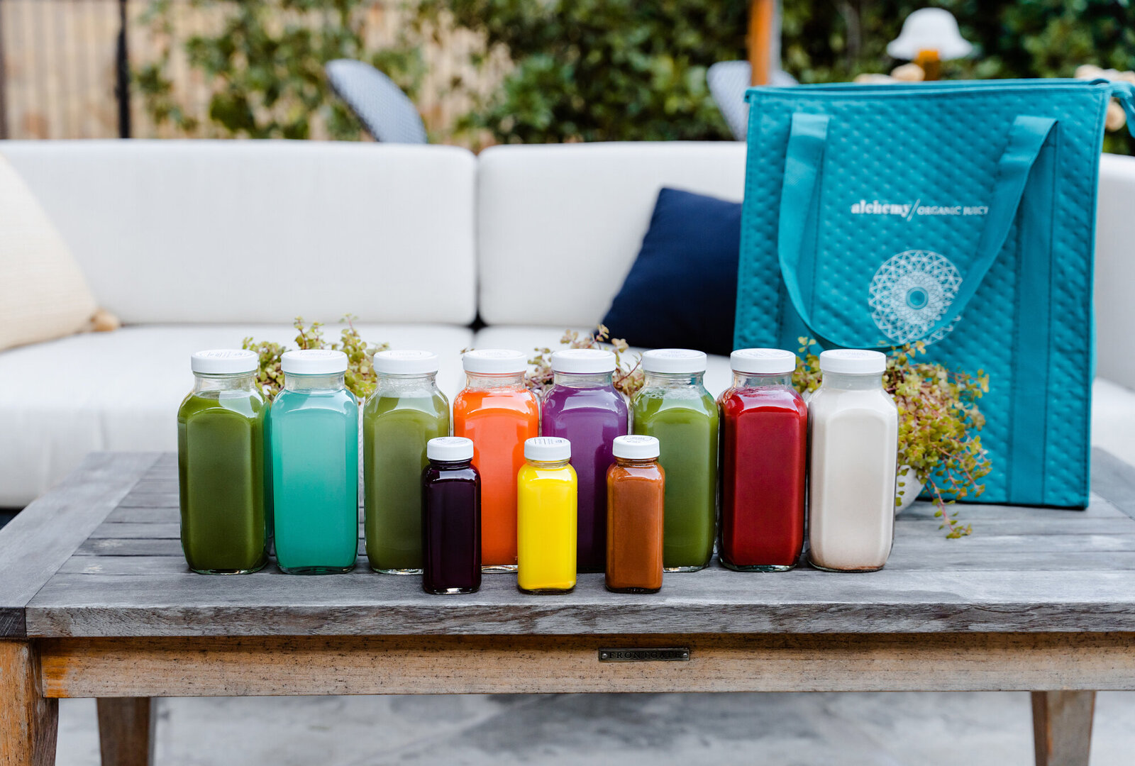 Branding Photographer, a large number of different juices are displayed on an outdoor table