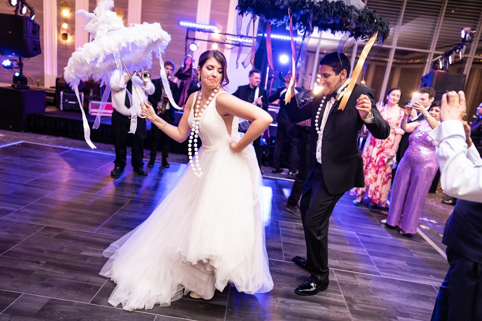 Bride and groom dance with umbrellas at Four Seasons New Orleans wedding