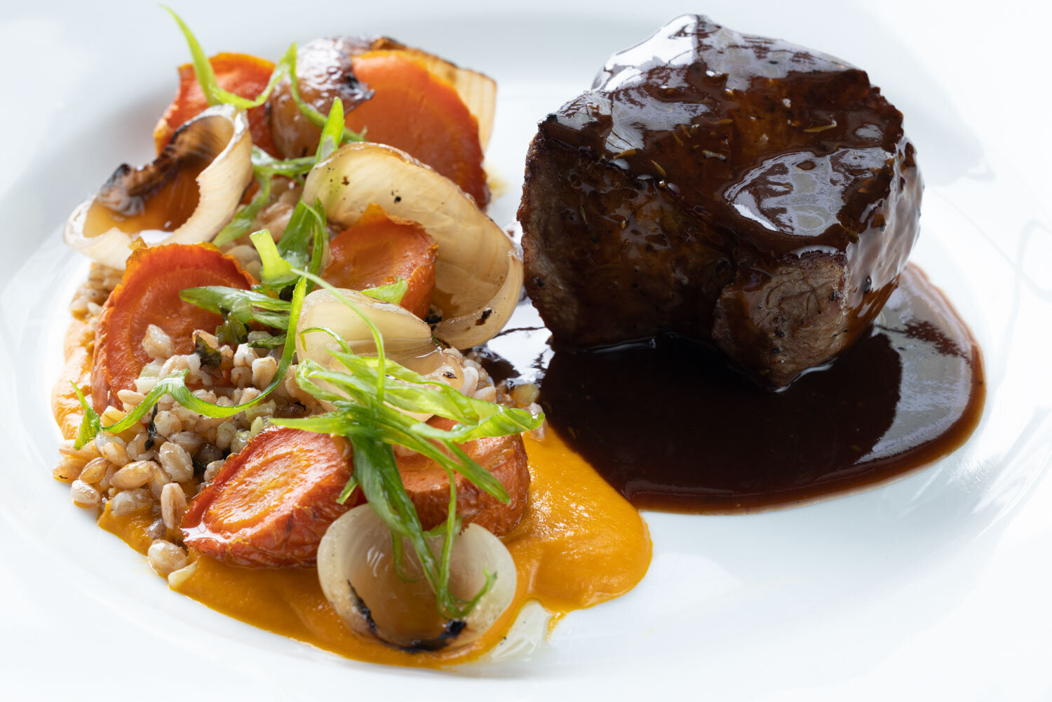 Braised beef with glazed carrots, pearl onions, and creamy sauce