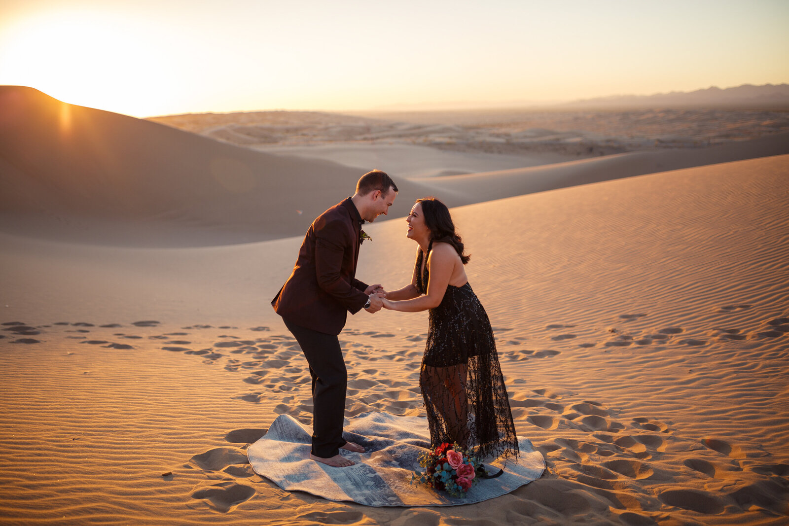 bride and groom holding hands during elopement ceremony in the dunes