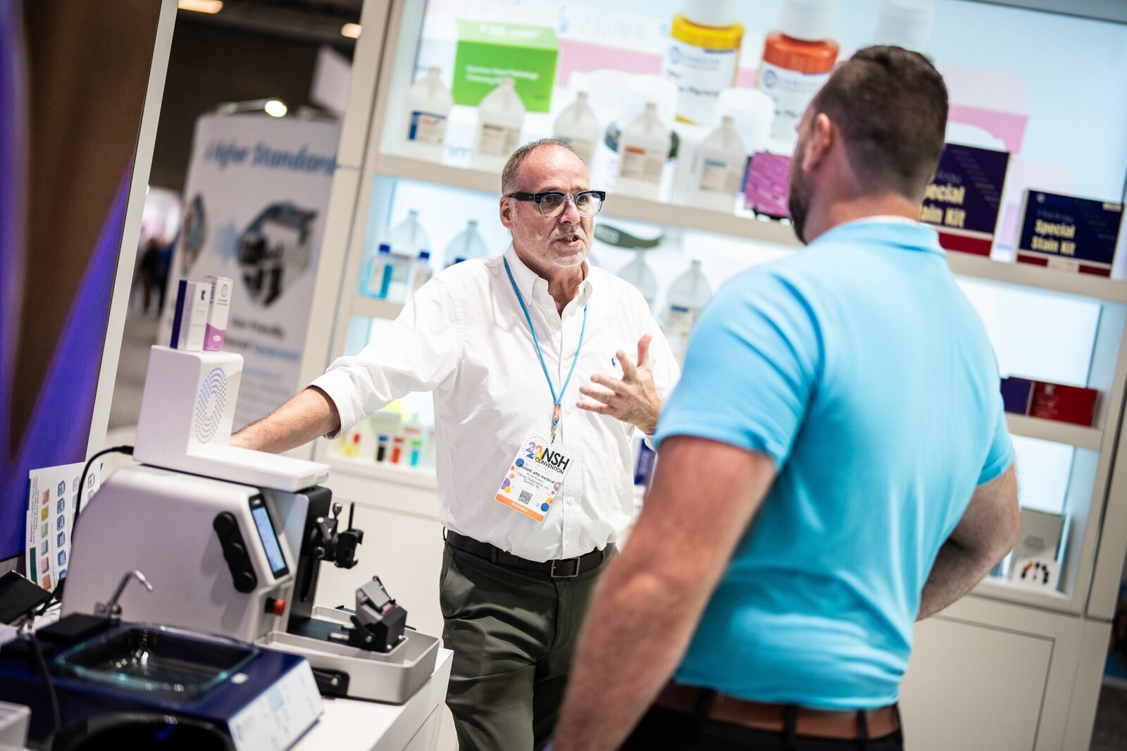 Company representative interacting with trade show attendee