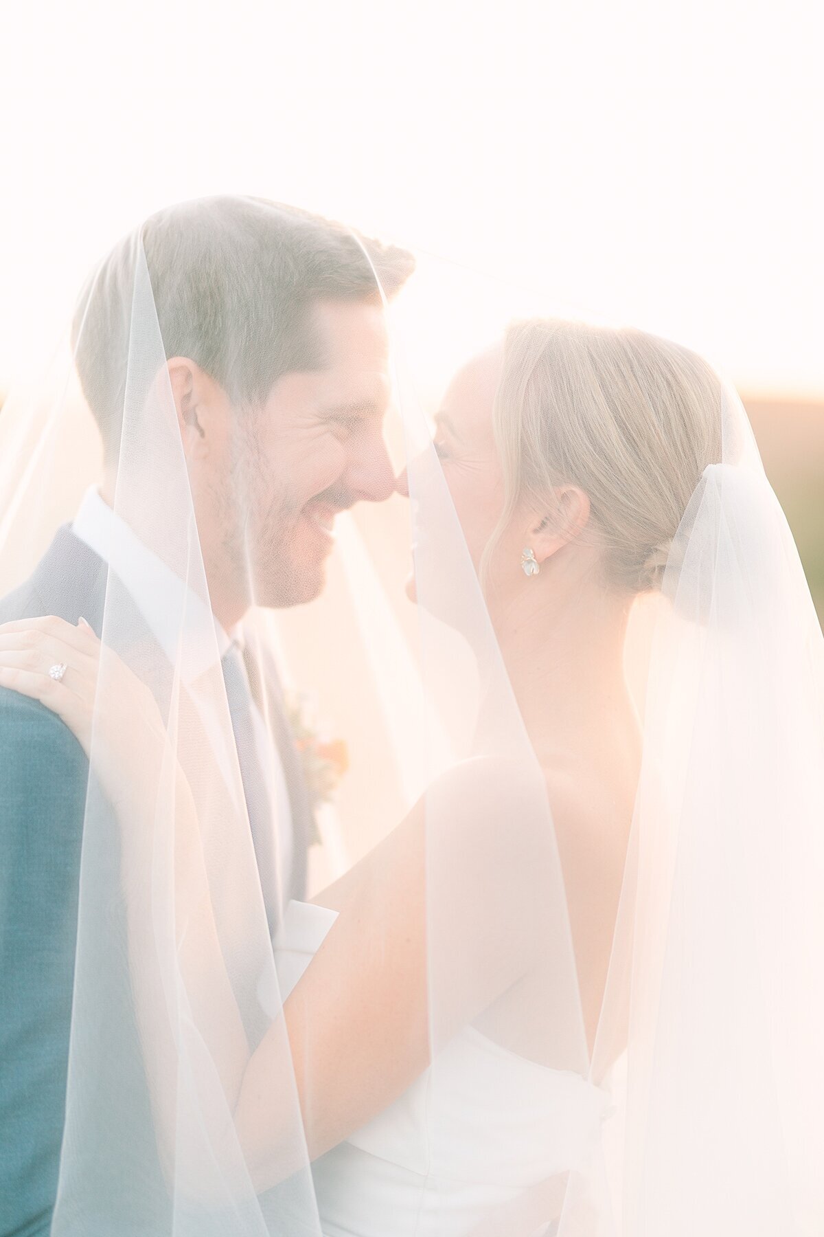 Couple smiling at one another during portraits at Jeune Perché wedding venue in Fallbrook, California photographed by wedding photographer, Bree Sherr.