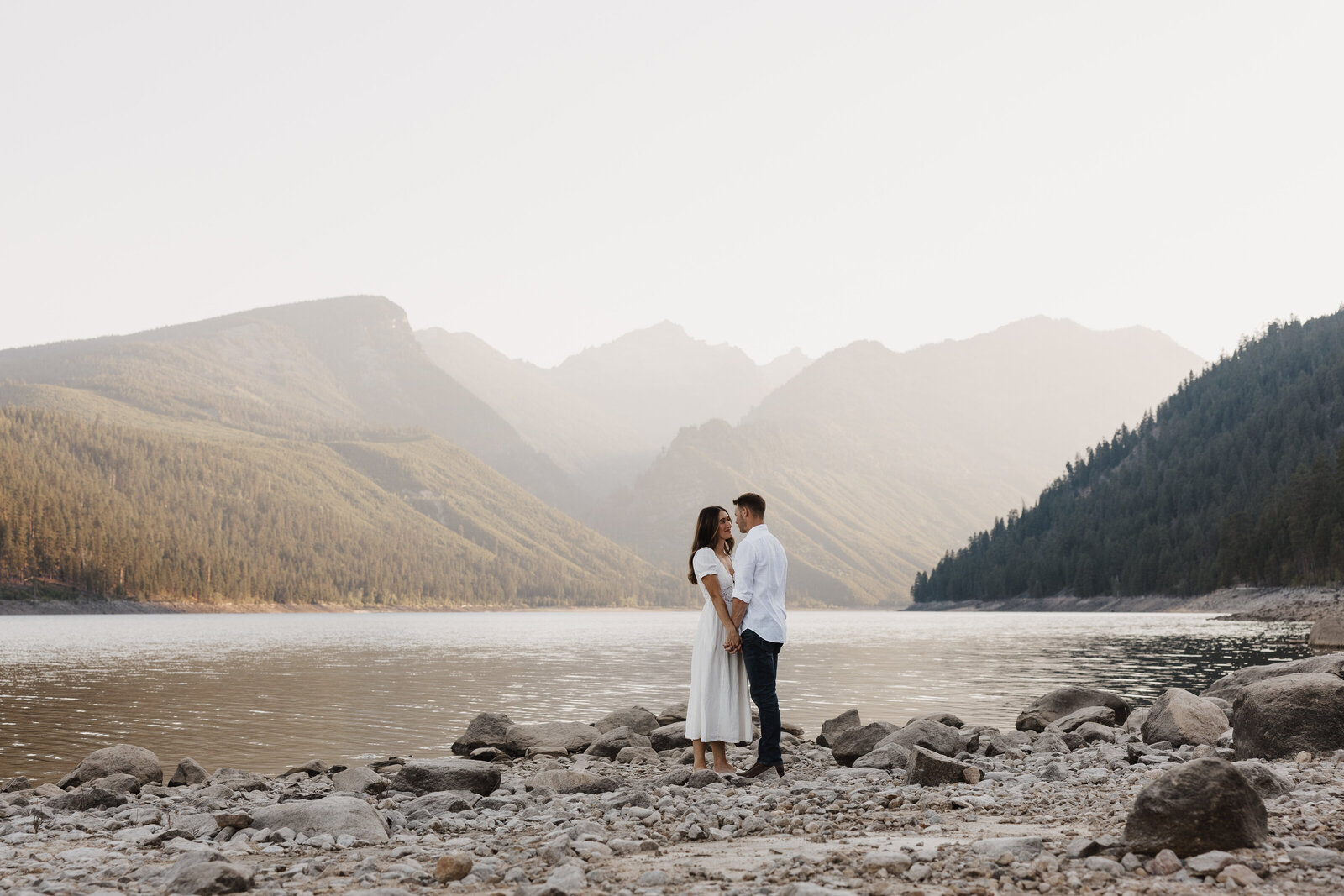 Stunning couple embracing each other during golden hour at Lake Como in Montana