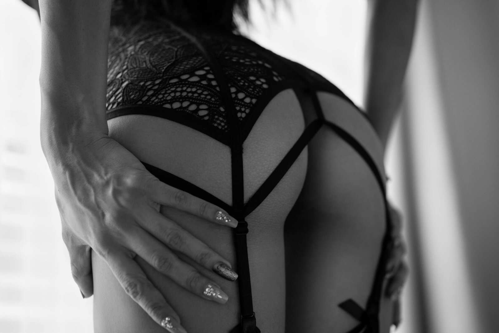 close of of a woman's backside in black lace lingerie